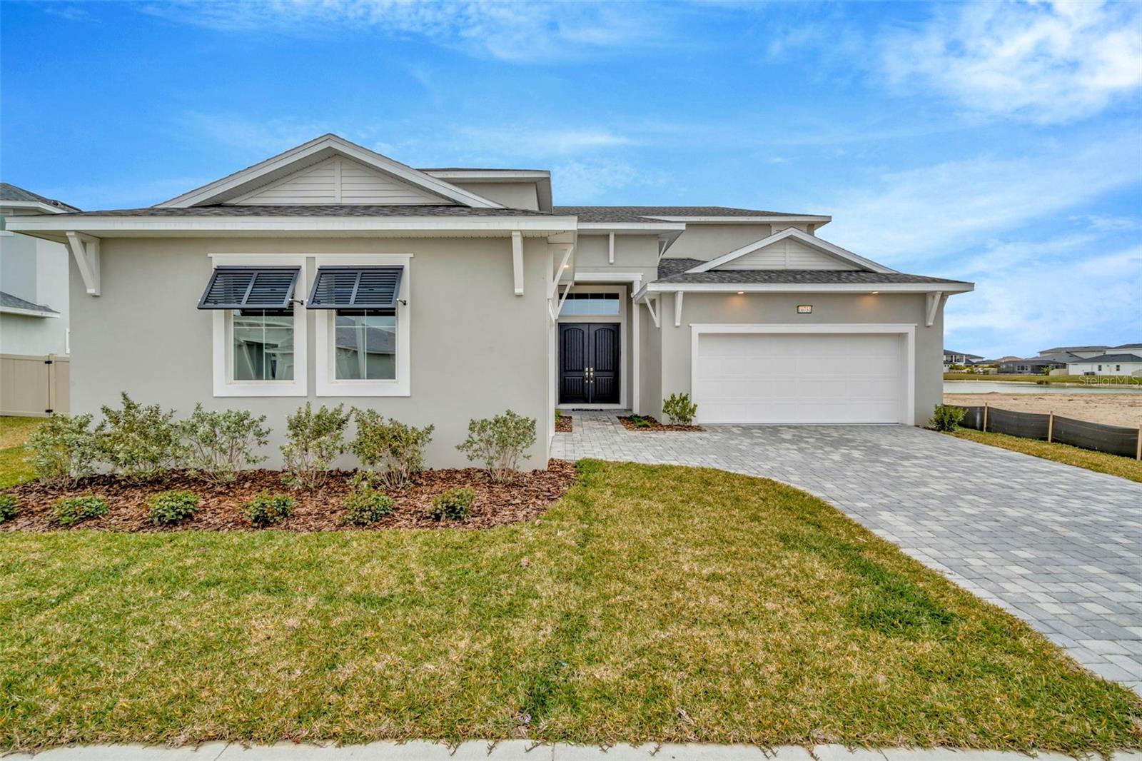 Spacious 2-Level Design with functional flow and elegant finishes, including 5 Bedrooms, 3.5 Bathrooms! Beautiful Wetland Views behind the home provide added tranquility. Open-Concept Main Level with seamless living, dining, and kitchen areas. 10-Foot Ceilings and abundant natural light throughout the main living space. Located on main level for privacy and convenience. Ensuite bath includes Oversized walk-in, frameless glass shower, Dual vanities and modern finishes. 4 additional bedrooms, 2 full bathrooms with contemporary fixtures and design. Spacious Bonus Room perfect for media, playroom, or home office. Designed for both style and everyday functionality. Move-in ready in a desirable, scenic community setting.