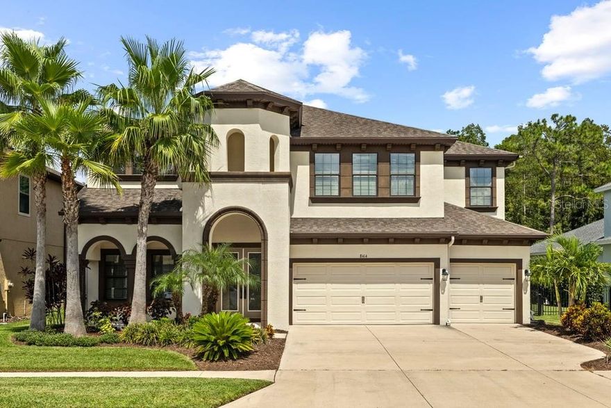 NEW PRICE, combined with modern Mediterranean Style luxury with 1000 sq. ft. of outdoor Florida Living space with Pool/Spa and Enclosure. This stunning home located in the highly sought-after Lakeshore Ranch gated community. Built in 2016, this home offers 6 bedrooms, 4 bathrooms, and spans 4,828 square feet of living space. Upon entering, a private den/study to the left greets you  before leading to the kitchen and living room. Living area features sliding doors that open completely blending the indoor living with the outdoor screened-in, heated SALT WATER pool complete with a paved patio and outdoor living space. The gourmet chef's kitchen combines style with functionality, featuring granite countertops, updated appliances, built-in oven and microwave, 5-burner gas stovetop / range with stone backsplash, oversized island seating 5 with sink, custom solid wood cabinetry, walk-in butler's pantry complete with wine cooler refrigerator and coffee bar. Living and dining room feature custom chandeliers and recessed lighting. First floor has a bonus media room that may be used as a home theater, game room, or in-law suite. Second floor master suite features an ensuite bathroom with split dual sinks, vanity space, private toilet, separate tub and tiled shower, and massive master walk-in closet. Remaining upstairs bedrooms feature plenty of space, Jack & Jill bathroom with closet storage. Home technology includes a security system and in wall pest control system. Lakeshore Ranch has 24/7 manned security with gated system. multiple community pools, fitness center, clubhouse, playground, basketball courts, tennis / pickleball courts; making it one of the most sought after locations in Land O Lakes, Florida.