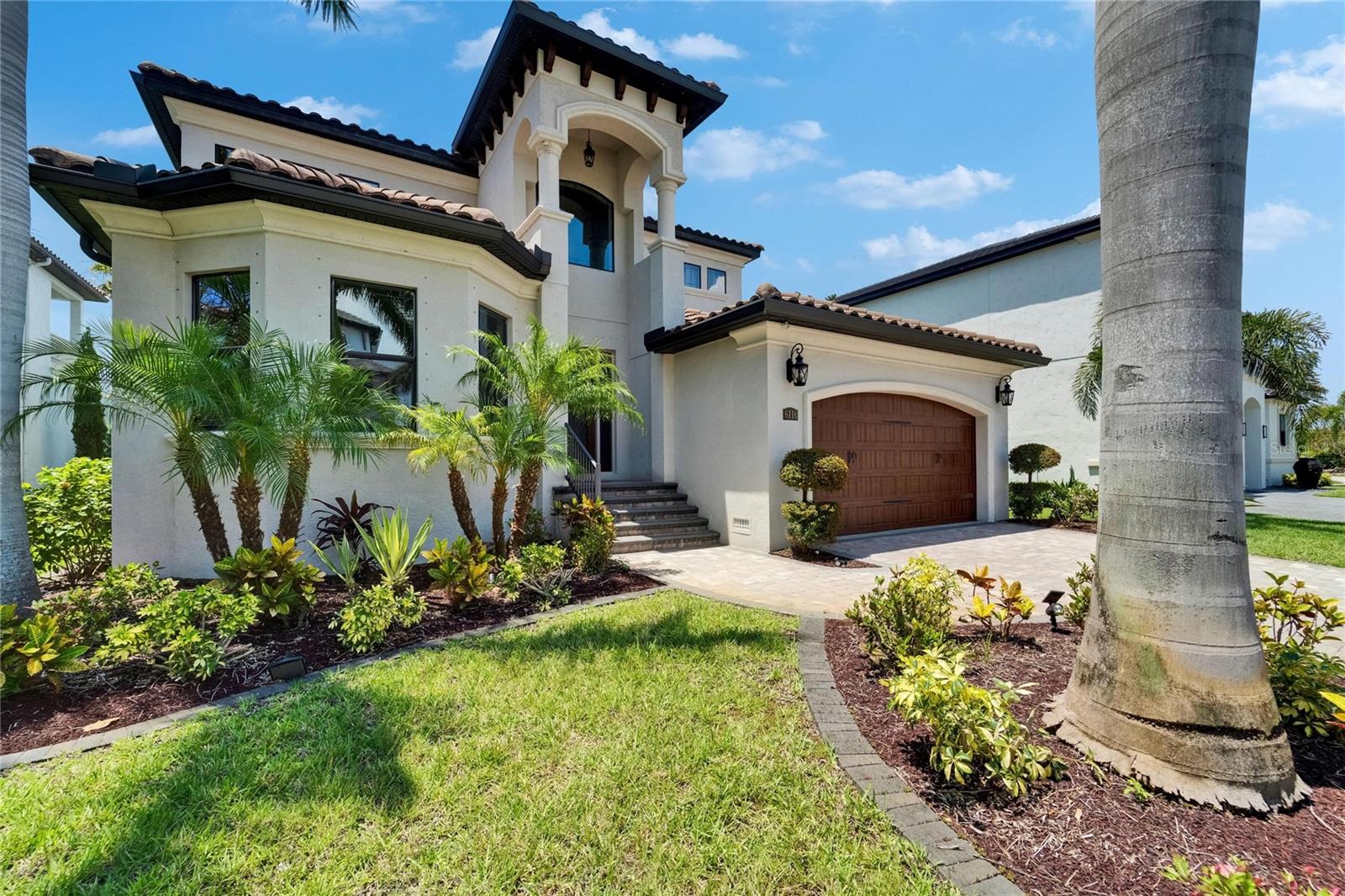This Luxury Home at 6116 Lagomar Lane, offers not just a dwelling space, but a LIFESTYLE – Now Leasing in the Exclusive Guarded Gated Community of Andalucía!!
Discover refined coastal living in this 3,795 sq ft custom two-story residence in the upscale, gated waterfront community of Andalucía in Tampa Bay. Thoughtfully designed with 4 bedrooms, 3.5 bathrooms, this home offers versatile elegance for both everyday living and upscale entertaining.
Step inside to a sunlit formal dining room with tray ceiling and Swarovski crystal chandelier, mirrored by a second in the gourmet kitchen. The chef’s kitchen features a quartz island with bar seating, top-tier stainless steel appliances, wine fridge, pot filler, and oversized double-door refrigerator—all seamlessly flowing into the open living area with polished wood floors and expansive sliders to the backyard. The living room boasts impressively high ceilings, and perfectly placed windows which provide a luxurious view from the interior balcony of the custom outdoor space.
The main-floor primary ensuite is a private retreat with walk-in closet, and direct balcony and backyard access. In addition, the main floor has a bonus room that may be used as a bedroom or study, a half bath convenient for guests and a laundry room.
Upstairs includes three secondary bedrooms—one ensuite, two sharing a Jack and Jill bath—plus a large loft with interior balcony overlooking the living room and backyard, perfect for entertaining.
Outdoors, enjoy a lushly landscaped paradise with covered rear porch, pond views, and a custom-built thatched roof chef’s kitchen with wood-fired oven, wet bar, and additional designated seating area with firepit—your own resort-style escape. Prime location for creating memories.
Extras include a 2-car garage, lush landscaping, recessed lighting, and premium finishes throughout. Residents enjoy access to tennis courts, clubhouse, waterfront pool, private beach, and marina with 16,000lb boat lift + 2,000lb Davit for jet skis. This property is in close proximity to excellent schools, hospitals, dining and shopping. With easy access to I-75, you can visit near other nearby cities such as Brandon, Tampa, St. Pete and Orlando.
Schedule your private tour today and elevate your lifestyle at 6116 Lagomar Lane.
