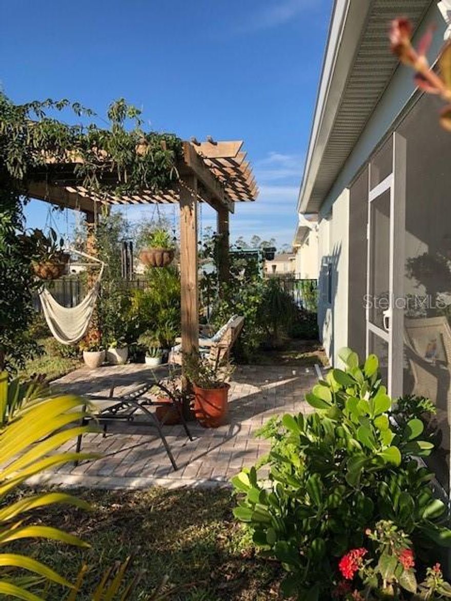 BACK ON THE MARKET AGAIN!! The buyer couldn't make it work so his loss could be your gain!

Here is your dream home on a lake in popular New Smyrna Beach, less than 2 years old and better than new! This artist and Master Gardner has put many extras into HER dream home for YOU to enjoy.  Black Wrought iron fencing around a large Pergola on a paver patio just off an extra-large screened Lanai.  The Native tropical landscaping is a haven for Birds and Butterflies and a lovely entrance into the large family room through FRENCH doors.  She hasn't neglected the practical either: the screened front porch, safety Solar film on the windows as well as blinds, front door glass insert (and blinds), 4 ceiling fans under cabinet lighting, UPGRADED APPLIANCES and it’s a SMART HOME for the Techie in the family. Right now, the third bedroom is her dining room, but if you have the need, make it a bedroom again!  Versatility is the hallmark of all dream homes!  Come see this one before it’s gone again!! ;Water: City