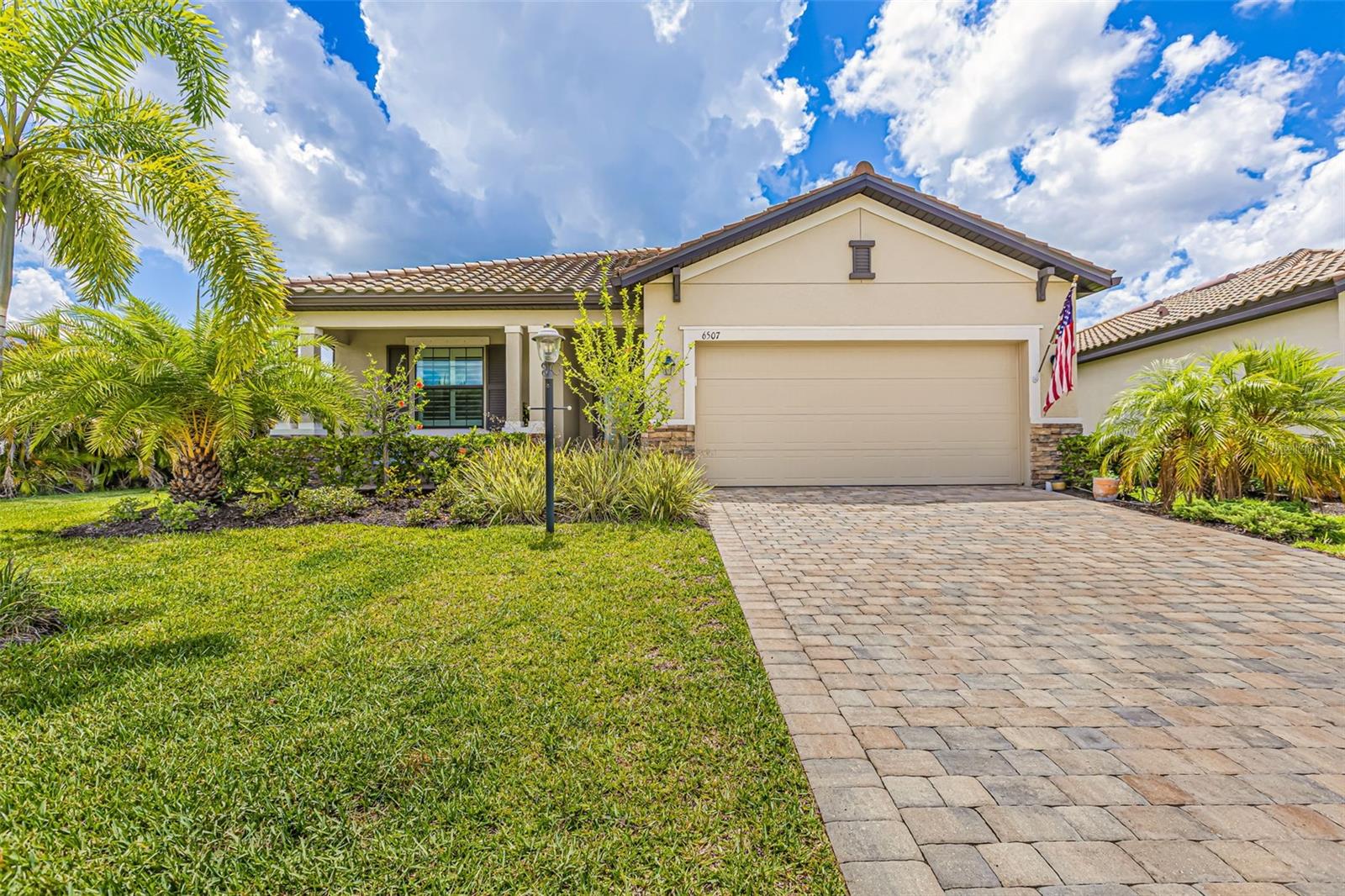 Step into a lifestyle of refined comfort and effortless luxury in the highly sought-after, solar-powered gated community of Polo Run at Lakewood Ranch. Built in 2021 and impeccably maintained, this 3-bedroom, 3-bath home offers just over 1,800 square feet of thoughtfully designed living space. From the welcoming paver driveway to the charming front porch surrounded by tropical landscaping, this home offers instant curb appeal and warmth. Inside, you'll find an open-concept layout accented by modern light grey tile flooring throughout, crown molding, and plantation shutters that provide timeless elegance. The gourmet kitchen is beautifully appointed with granite countertops, stainless steel appliances, a gas range, custom tile backsplash, and a large center island with pendant lighting and bar seating. It opens to a spacious great room and dining area, creating the perfect flow for entertaining or casual living. Step through sliding glass doors to your own private retreat. The panoramic screened lanai reveals a resort-style saltwater pool with sun shelf and water features, all overlooking a peaceful pond. The primary suite is a true escape featuring two walk-in closets, including custom closet systems, and an en-suite bath with dual vanities and an extra-large tiled walk-in shower. One guest bedroom functions as a private guest suite with its own en-suite bath, while the third bedroom provides flexibility for guests or a home office. Living in Polo Run means more than just owning a home. It's a commitment to sustainability and elevated living. As Lakewood Ranch’s premier solar-powered community by Lennar, Polo Run features 423 energy-efficient homes equipped with SunStreet solar technology, providing eco-conscious savings without compromising on comfort or style. HOA services include lawn maintenance, irrigation, gated security, and full amenity upkeep so you can spend more time enjoying life. Resort-inspired amenities include a stunning clubhouse, sparkling pool, state-of-the-art fitness center, tennis and pickleball courts, bocce ball, dog park, playground, and gathering spaces for a true sense of community. Ideally located in Lakewood Ranch, residents are minutes from top-rated schools, the shops and restaurants of UTC, championship golf, parks, and over 150 miles of walking and biking trails. Easy access to downtown Sarasota, cultural venues, and the world-famous white sand beaches of Florida’s Gulf Coast. **THIS PROPERTY QUALIFIES FOR A 1% LENDER INCENTIVE IF USING PREFERRED LENDER. INQUIRE FOR MORE DETAILS.**