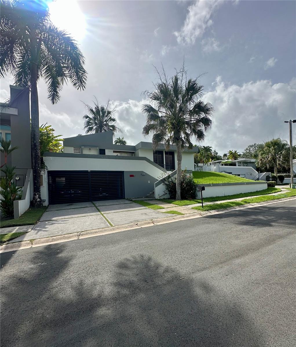 Exceptional Value & Potential in Paseo de la Fuente – San Juan, PR
Located in the desirable gated community of Los Paseos, this spacious residence presents a rare opportunity to renovate and personalize a property in one of San Juan’s most well-established neighborhoods. Positioned on a generous 1,639 sq. meter lot, the home offers over 3,100 sq. ft. of interior living space—an ideal option for those who value comfort, space, and long-term investment potential.
Recently appraised at $1,373,000 in its current condition, the home is being offered as-is, with reasonable offers welcome.
The layout includes 4 bedrooms, 2.5 bathrooms, generous living and dining areas, covered terraces, a two-car carport, and a photovoltaic solar system (personal property). The expansive backyard is a highlight, featuring mature fruit trees and vibrant tropical landscaping, including: Dragon Fruit, Soursop (Guanábana), Banana Trees, Plantains, Avocado Tree & Gardenias.
While the property shows signs of age and is ready for updates, its solid construction, large footprint, and sought-after location make it an outstanding candidate for a thoughtful renovation. An elevator, currently not in use, offers additional future functionality.
The Los Paseos community features controlled access, a peaceful setting, and convenient proximity to schools, shopping centers, restaurants, and major roadways—providing easy access to San Juan’s dynamic lifestyle.
This is an excellent opportunity to add value and create a truly unique living space in a prime location.
Location Note:
Just past the main entrance of Los Paseos, Paseo de la Fuente is conveniently located at the first right turn. This prime location within the community enhances accessibility and privacy.