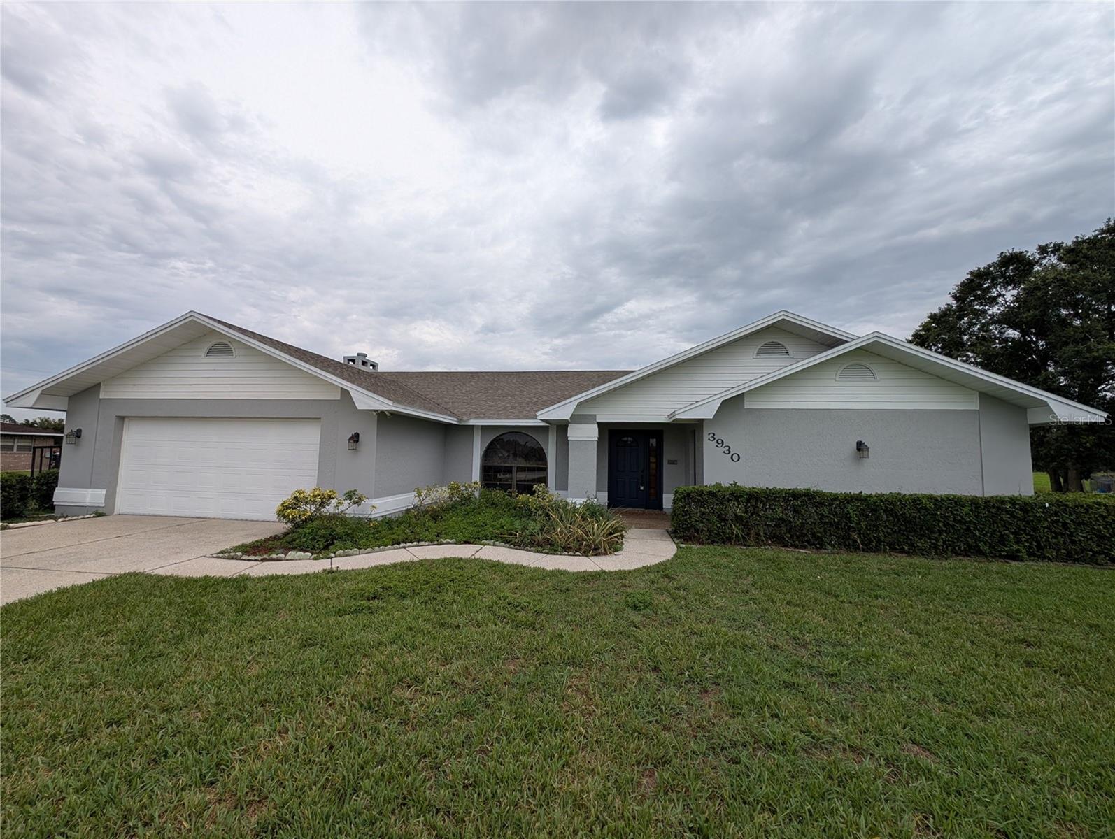 Beautiful executive home in a serene farm setting, surrounded by strawberry fields. This spacious four-bedroom, two-bathroom, almost 2500 square foot ranch-style home in north Plant City is conveniently located in a rural area away from traffic and congestion but with easy access to all major highways and interstates. This home was plucked right out of a high-end, gated, HOA community with NO HOA! It features brand new luxury vinyl plank flooring, new paint, and a fantastic open and split floorplan. The spacious kitchen features lots of counter space with bar eating space as well as a nook for a breakfast table. The family room has a beautiful wood-burning fireplace with an earthen brick hearth. Entertain guests in multiple spaces with a formal living room, formal dining room, family room and a large, covered back porch. Outside the property has a lush St Augustine lawn watered with an automatic irrigation system, a partially fenced back yard perfect for pets, and wonderful views of the strawberry fields.