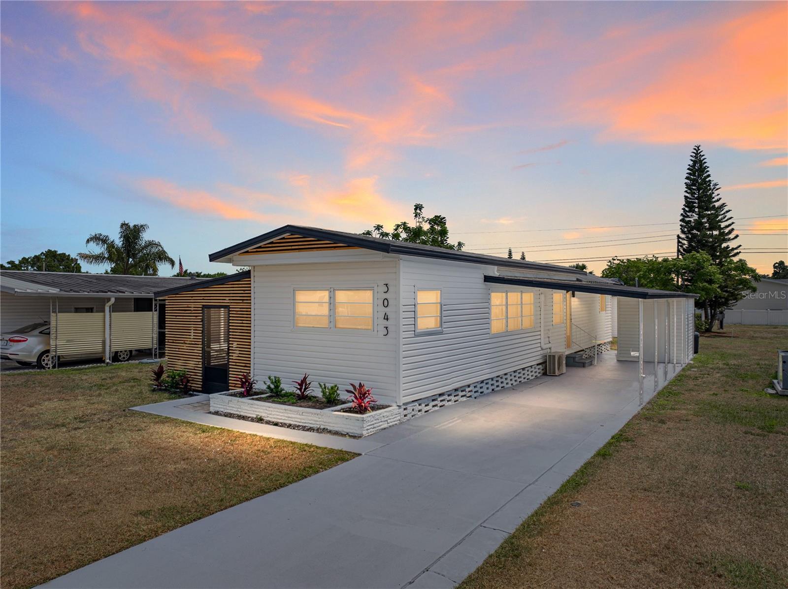Discover this beautifully renovated 2-bedroom, 2-bathroom mobile home that’s move-in ready and full of charm! Located in the active 55+ community of Skyview Estates, this home has no lot lease, as the land is owned! This home has been freshly painted inside and out, this home features eye-catching wood-slat siding accents that give the exterior a stylish, modern touch. Step inside to find brand-new luxury vinyl plank flooring throughout, offering both durability and a clean, updated look, a warm anchor to the bright fresh white walls. The kitchen has gotten a facelift with resurfaced cabinets, updated hardware and both bathrooms have been upgraded with modern vanities. The spacious carport provides covered parking and convenience, while the detached workshop adds incredible value—perfect for storage, hobbies, or projects. The Skyview Estates community is gated with a clubhouse, shuffleboard, and a dock for fishing! Whether you’re downsizing or just looking for your perfect Florida retreat, this upgraded home combines comfort, style, and functionality in one affordable package. Don’t miss your chance to see it!