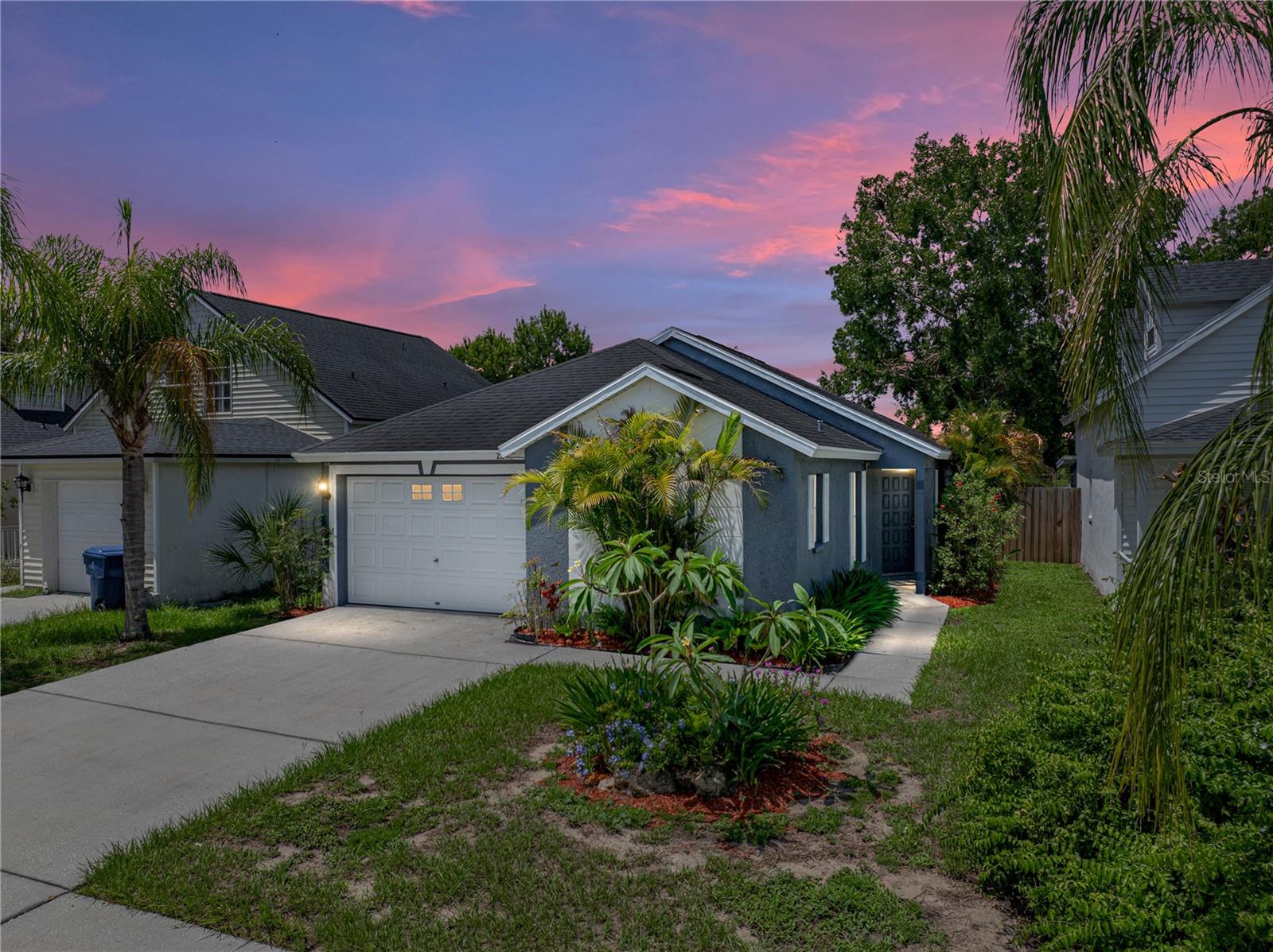 Breathtaking lake views and a beautifully landscaped setting set the tone for this 3 bedroom, 2
bath residence in the low HOA community of Willow Pointe, ideally positioned in a central Lutz
location. With 2 spacious ensuites, a 1 car garage, and a layout designed for entertaining, this
home offers a true retreat in a prime location! An inviting interior awaits, featuring high ceilings,
open sightlines, and easy-care tile flooring that extends throughout the main living areas. The
expansive living room connects effortlessly to a light and bright kitchen, complete with
breakfast bar seating, a pantry, a range, and a dishwasher. Just beyond, the eat-in dining
space leads to the screened back porch, perfect for morning coffee with a view. Tucked away
for maximum privacy, the first bedroom suite impresses with its 20x16 footprint, dual closets, 2
ceiling fans, vinyl flooring, and an ensuite bath with a tub/shower combo. On the opposite end
of the home, the second suite has plush carpet, soaring ceilings, a generous walk-in closet,
and its own private bathroom. The third bedroom sits at the center of the house and functions
beautifully as a home office, featuring French doors and a closet with built-in organizers. Out
back, paradise awaits. A tropical landscape frames the serene lake view, while a screened
porch and open patio offer multiple spaces to relax and soak in the peaceful surroundings.
Located just minutes from local shopping, dining, and entertainment, this property is your
ticket to lakeside living. Don’t miss your chance; schedule your private showing today! Per Pasco permitting the roof is 2016 and the A/C is 2015. Seller is motivated bring your offers.