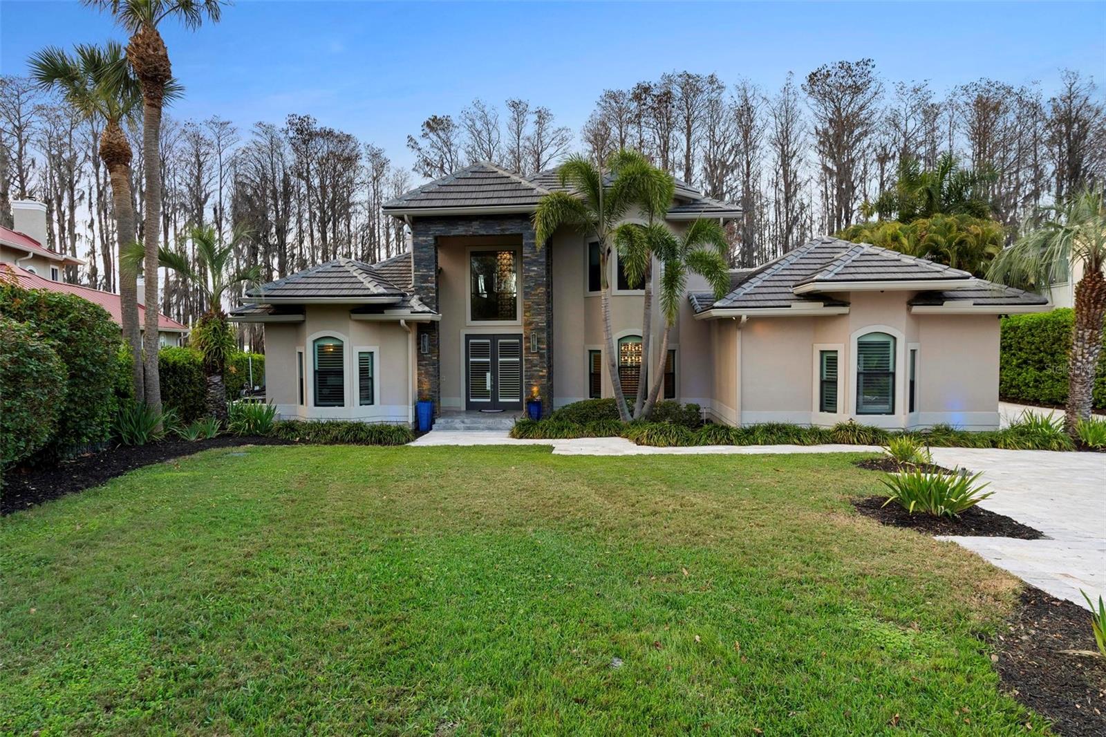 One or more photo(s) has been virtually staged. LAKEFRONT GATED HOME, located in North Bay Neighborhood in Dr. Philips with access to Butler Chain of lakes. This remarkable home provides stunning marble and Travertine floors throughout, Gourmet kitchen, Gas Stove High-M Appliances, Splendid walking Wine Cellar with two Wood Burning Fireplaces and Stunning view in the Master Bathroom.
The water Access provides a covered Boat Dock, Boat hoist, Jet ski port - Everything designed for Lake Life Style entertainment with the family.
Home provided with a gas emergency generator and light system in the front, back and dock.