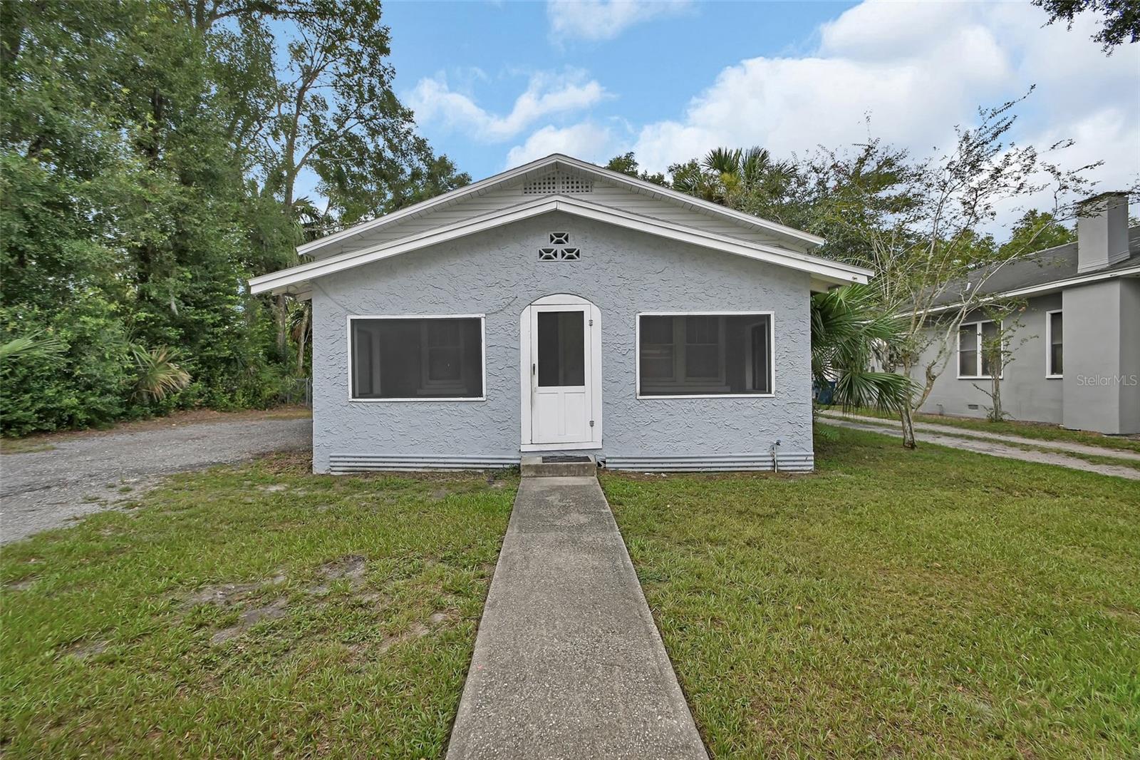 CASH ONLY!! CALLING ALL INVESTORS! This home will not qualify for financing! This charming 2 bedroom, 1 bath home has endless possibilities and tons of character. The home has a large, screened front porch. The great room and dining area have original hardwood floors that are charming, but could use a little TLC. There is a fireplace, but decorative only. The two bedrooms are carpeted with built-in closets. The kitchen has a small eat-in area. The utility room has washer/dryer hookups and plenty of room for extra storage. Large fenced backyard. Appliances are 3 years old. Exterior air handler 3 years old. Great investment opportunity!