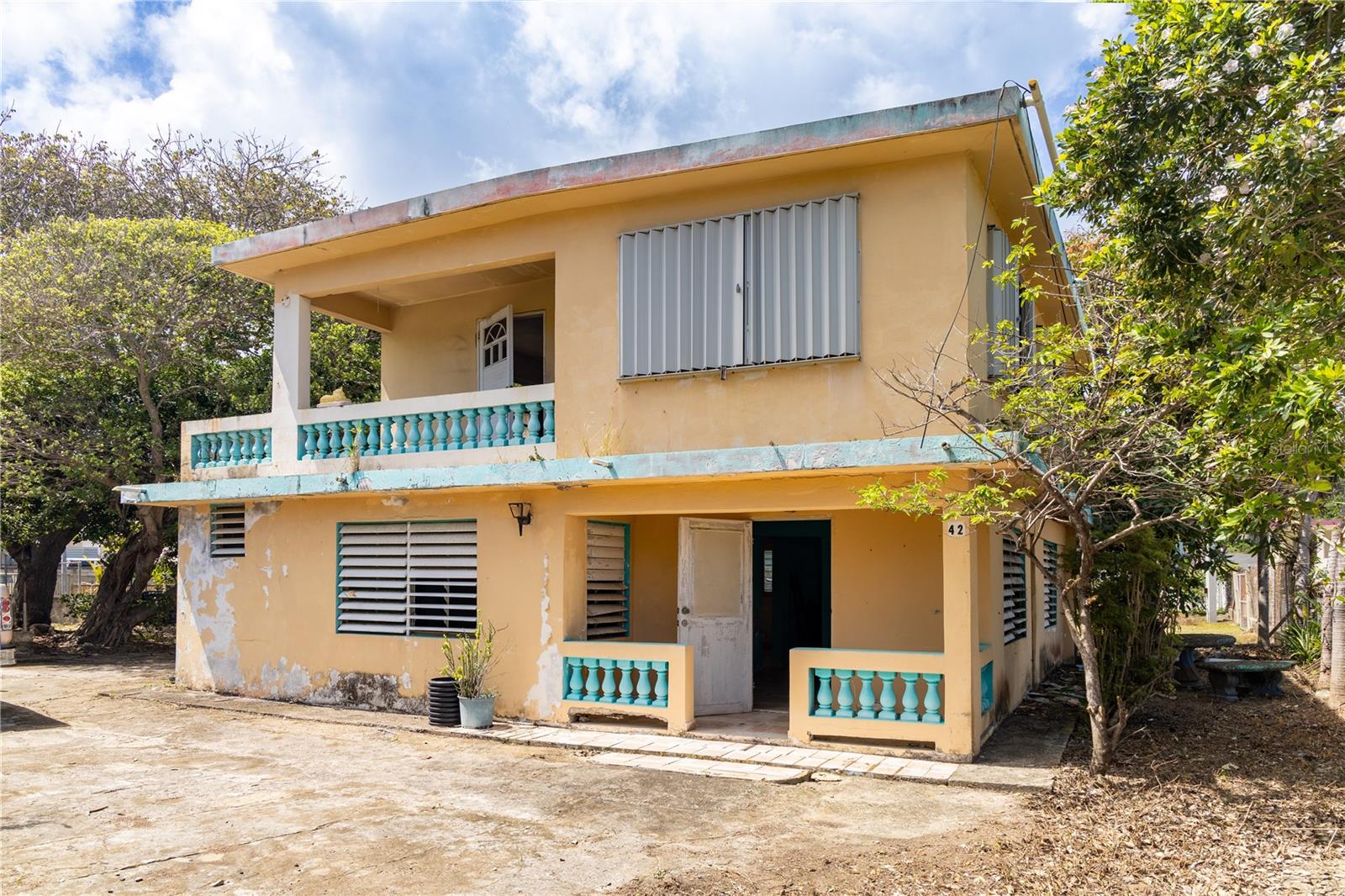 LOCATION, LOCATION, LOCATION! This is a fixer-upper with a future. With the right vision and investment, this property could become someone’s dream coastal retreat. Located directly across from the ocean and less than a ten minute walk to Surfer’s Beach, La Chata Beach, the ferry terminal, and the restaurants and markets of Isabel II. This two-story structure offers a rare chance to create something truly special in a highly desirable location.
While the principal structure will need a full remodel, the layout provides a foundation to work with. Each apartment includes a private balcony and entry, a kitchen, living area, two bedrooms, and one bathroom. The layout lends itself to a flexible renovation: keep it as a multifamily property, create two income-producing rentals, or convert into a spacious single-family home with ocean views throughout.
The outdoor space has a carport, freestanding cabana equipped with water and power and is ample enough to accommodate a pool, garden and an outdoor living area. The lot is partially fenced and offers double access from both the front and back of the property for ease of entry, parking.
For those with design vision, the potential is easy to see. Adding glass sliders to the upper unit could transform the living area and balcony into one seamless space with amazing ocean breezes and views. Larger glass louvers or Bermuda-style windows in the master could frame the water view beyond and flood the space with natural light. Even more potential lies in the vertical: adding a third floor or rooftop access would give you unobstructed, panoramic ocean views—perfect for a rooftop deck, penthouse unit, or viewing terrace.
This property is for someone who understands the value of location and is ready to unlock the full potential of a prime beachside location.