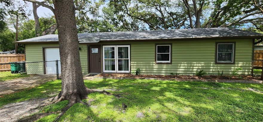 NEW PRICE IMPROVEMENT! You can be a Safety Harbor resident with this charming, affordable updated home on an oversized fenced lot. Enter the open living room and dining room and view the sweet backyard through double atrium doors with built in shades. Access the kitchen from the hallway or the dining area. Many upgrades include kitchen cabinets, counters and appliances, vinyl flooring throughout, bathroom vanity, sink, and bidet. New roof, kitchen and wood fencing were all installed in 2022. Separate laundry room with washer and dryer is inside! Garage with newer garage door has been a bedroom/family room in the past and can easily be reconverted into living area. Walk or ride to historic downtown Main Street with numerous shops and restaurants, special events and fabulous library. Very close to Philippe Park, The Marina Park and Safety Harbor Resort and Spa. Pedestrian and bike trail now goes into Tampa connecting Bayshore Blvd with the Courtney Campbell Causeway. This home is only footsteps from Safety Harbor Elementary School and Safety Harbor Middle School. Enjoy the freedoms of living in a non deed restricted neighborhood with NO HOA fee and NO flood insurance required. Life is good in the Harbor!