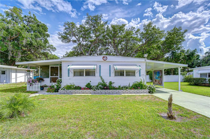 Easy Florida Living in a Prime Zephyrhills Location! Tucked into a welcoming 55+ community on the west side of Zephyrhills, this well-maintained 2-bedroom, 2-bath home offers a comfortable and uncomplicated way to enjoy Florida living. From the moment you step inside, the open layout creates a natural flow between the living room, dining area, and kitchen, making the space feel both functional and inviting. Laminate flooring runs throughout, giving the home a clean, updated feel, while the bright kitchen offers a cheerful place to start the day or gather with friends. A new roof installed in 2025 adds peace of mind, allowing you to focus on enjoying your surroundings rather than worrying about maintenance. Outside, the home continues to deliver with spaces designed for everyday relaxation. The screened room is perfect for enjoying the breeze without the bugs, while both the front and back sitting areas provide options for quiet mornings or winding down in the evening. The covered carport adds convenience, and the storage shed complete with washer and dryer keeps everything neatly tucked away. The location ties it all together, placing you just minutes from shopping, local dining, medical facilities, and nearby destinations like Tampa Premium Outlets. Whether you're looking for a seasonal retreat or a full-time residence with low-cost living, this home offers a lifestyle that is easy to settle into and even easier to enjoy.