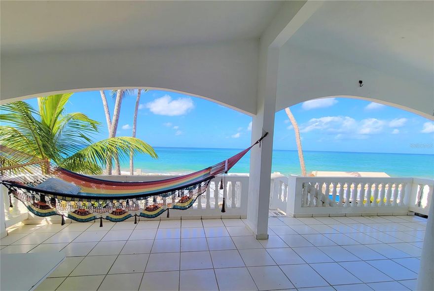 Spectacular opportunity to live on the beach in Paradise! Captivating ocean views and gorgeous sand right outside your door. This two-level home has been affectionately known as Casa Mac for years & was built by it's owners in 1990 and revised in 2003. A long time family home with 2 units located in Parcelas/ Stella on deeded land. The first floor consists of 3 bedrooms and 2 baths with a walkout terrace & a successful rental history. The 2nd level has 2 bedrooms/ 2 baths with sweeping ocean views and has never been rented. Enjoy the best sunsets & views of Desecheo from your spacious balcony. This home is close to everything in town and is very close to the famous Villa Cofresi! This is truly a beach sanctuary.   Home has approximately 3,000 sf, sits on a 453sm lot and has 3 cisterns- 250 gallons each with pump. Paradise awaits! Qualified "CASH" buyers call for your viewing today! Offers welcome!