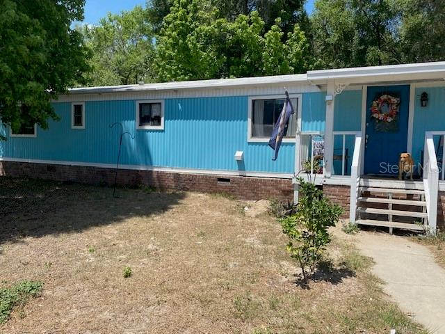 3 bedroom 1 and half bath singlewide mobile home. Owner have made many upgrades. Adding a 3rd bedroom and a large 12 X 23 living room out of the original back porch. Wood looking laminate floors and a large dining and kitchen area give this home the extra room that you need. Owners are animal lovers so please do not let the cats out or the backyard animals in. Another nice feature is that the land behind the home is a designated green area and will don't be built on. Yard is chain length fenced and divided into sections. Primary bedroom has attached bathroom with sink and commode, shower stall has been removed to update, but currently storage space at this time. New owners can finish this if they would like. Owners are very motivated!