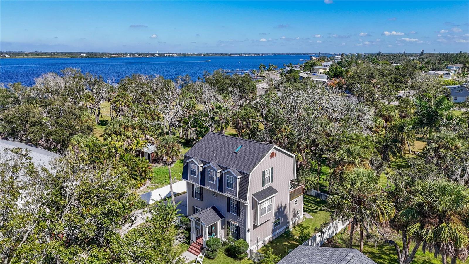 This unique elevated, waterview property backs up to a tranquil 1.6 acre waterfront private park with a boat ramp- (Partial ownership TRANSFERS to the buyer of this property).  Enjoy fishing, swimming, or taking your kayak or jet skis out on the water.  On the first floor you will find an oversized garage with storage space with an elevated laundry room, half bath and a lovely loft area.  You will find the main living area on the second floor with the kitchen, dining room, living room with fireplace, and a nicepowder room.  A generously sized screened porch and an open deck share the awesome waterview.  On the top floor you will find the primary bedroom, primary bath, the two guest bedrooms that share a hall bath.  This property has a fenced in yard perfect to keep your fur babies in and allowing easy access to your waterfront park.  Tons of parking for all of your toys and boats.  The Riverwalk extension is walking distance from this home and adds to your active Florida lifestyle.  Walk or bike ride to your favorite restaurants along the Bradenton Riverwalk. Perfect for kayakers, SUP, and jet skis too. No deed restrictions here! East of Historic River District & popular Downtown Riverwalk. Short bicycle or car ride to the farmers market, restaurants, park, library, public art, shopping, The South Florida Museum, Manatee Historical Village Park, Art Center Manatee, Local Award Winning Breweries, Manatee Performing Arts Center, or Lecom Baseball Park. Short distance away from the best GULF beaches, Sarasota Airport and attractions, St Pete 25-minutes away, Tampa Airport 45 minutes, Great centrally located home!  Buyer to verify measurements.