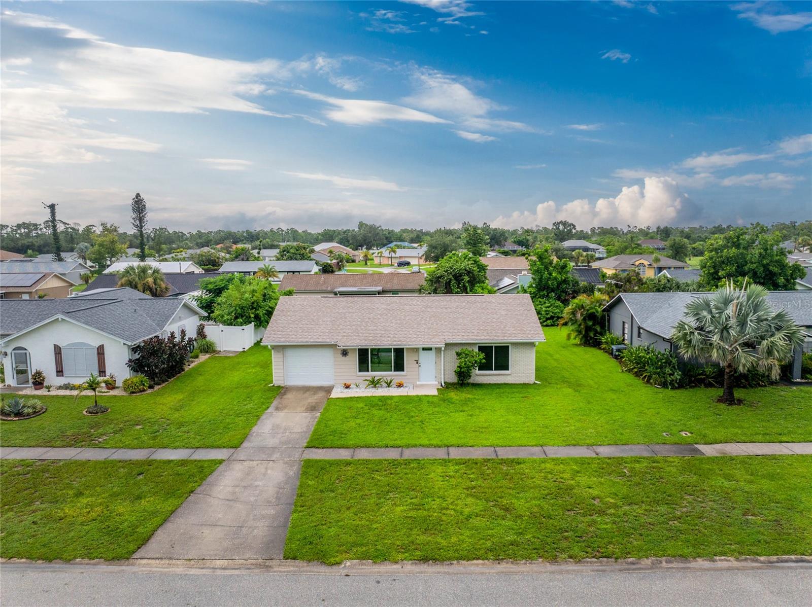 Take a look at this UPDATED 2 bedroom/2 bath home in the Gardens of Gulf Cove! Impact windows (7) installed for peace of mind. With both laminate and tiled flooring throughout, maintenance is easy! The very open floor plan features living/dining areas, with sliding glass doors to the lanai. The updated KITCHEN has soft close wood cabinetry and new countertops, large stainless steel sink, and appliances include: Samsung smooth top stove and microwave, Whirlpool dishwasher and LG double door refrigerator. (all stainless) The primary bedroom has a wall closet, ceiling fan and ensuite bath, which features an updated vanity and toilet, combo tub/shower, and large linen closet. The Guest bedroom has a ceiling fan and wall closet also. The Guest bathroom also has an updated vanity and toilet, tiled flooring and combo tub/shower. The garage houses the Affinity washer and GE dryer, and has an overhead garage door opener. The screened lanai is a great place to enjoy morning coffee and just enjoy some fresh air, plus there's a concrete patio for your grill and outside furniture. The shed is the perfect place for garden tools and other storage! Chain link fencing keeps the kids and the pets contained! Roof was replaced in 2023 and the electrical panel and AC in 2021. The Gardens of Gulf Cove has a great location,with easy access to either Englewood or Port Charlotte. First established in the early 1970's, today it consists of 986 single family home sites and features two facilities (Clubhouse and Recreation Center) each with a pool and multiple amenities for Gardens of Gulf Cove residents, not to mention underground utilities, central water/sewer, sidewalks and street lights, and RV/boat storage. Amenities include clubhouse and recreation center, 2 pools, tennis courts, bocce ball, shuffleboard and lots more! Shopping is just across the street and beaches are within a 15 minute drive.