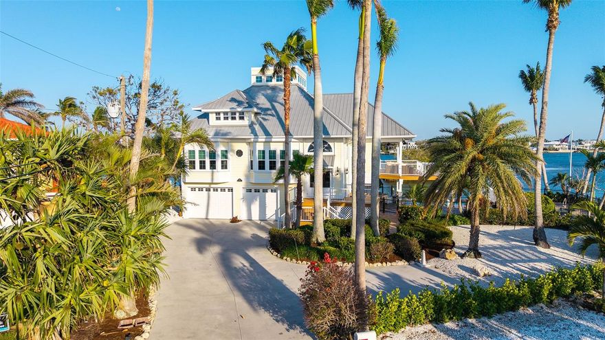Experience the epitome of refined coastal living at 924 Casey Cove Drive, where elegant architecture meets breathtaking natural beauty on exclusive Casey Key Barrier Island. This immaculate waterfront estate boasts 246 feet of pristine shoreline offering mesmerizing 180-degree Intracoastal views—a perfect setting to witness dolphins playfully dancing at sunrise, spectacular crimson sunsets, and tranquil waters teeming with fish and waterfowl. The exquisite residence features soaring ceilings, abundant natural light, and an enchanting cupola offering rare gulf-to-bay vistas—ideal for morning reflection, afternoon reading, or evening cocktails. Indulge in the luxurious outdoor oasis with a resort-style pool and spa nestled amid professionally landscaped tropical gardens, or retreat to the private screened balcony off the primary suite where gentle sea breezes carry the soothing sounds of water lapping against your seawall. This meticulously maintained sanctuary includes premium upgrades such as remote-controlled hurricane shutters (2015), hurricane impact windows (2017-2024), modern elevator (2016), durable metal roof (2003), whole-house generator (2025), engineered wood flooring (2016), four-car garage with epoxy coated flooring (2020), freshly painted interiors and exteriors (2025), and a recently refurbished 19,000-pound boat lift—your gateway to endless aquatic adventures. Perfectly positioned on Casey Key's coveted shores, this turnkey masterpiece offers the discerning buyer that increasingly rare combination of privacy, sophistication, and waterfront grandeur, just minutes from both historic Venice and downtown Sarasota's renowned cultural amenities yet worlds away from ordinary living.