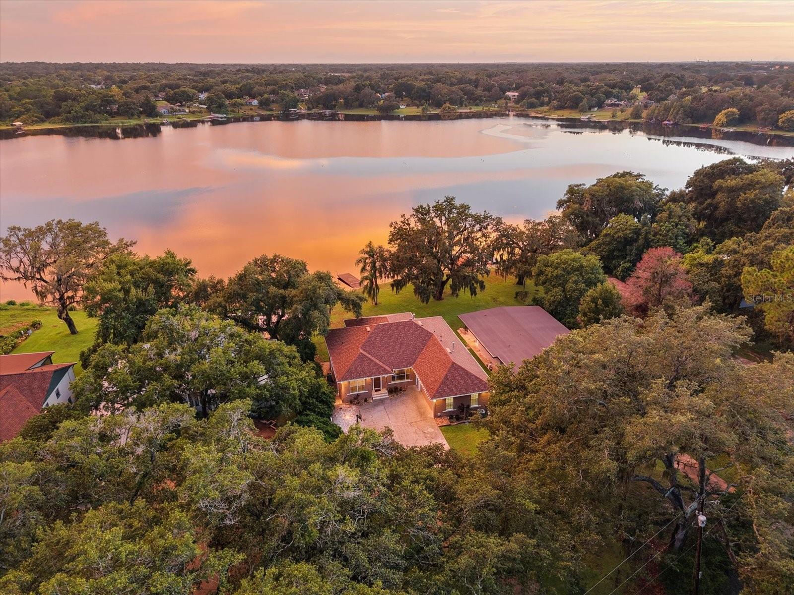 Location takes on a whole new meaning with this exceptional LAKEFRONT HOME. Perfectly positioned to capture PANORAMIC VIEWS of SKIABLE Lake Rose from nearly every room, this beautifully updated and move-in ready residence offers both tranquility and convenience.
Privately nestled at the end of a LONG DRIVEWAY in a quiet, NO-HOA neighborhood, this home offers rare seclusion with ample space for multi-generational living. Boasting 5 bedrooms, 4 full bathrooms, a private office, a spacious bonus room, 2 full kitchens and 2 laundry rooms, there’s room for everyone! If you are looking for an IN-LAW SUITE the private access to the downstairs makes it the perfect space!
High ceilings on both levels—an uncommon feature—create an open, airy ambiance throughout.
Thoughtful upgrades include:
NEW Roof (2023)
NEW Exterior Paint (2025)
NEW Dishwasher (2025)
NEW Gas Water Heater (2023)
NEW Triple-Panel Sliding Glass Door (2025)
Additional premium features include crown molding throughout, a COZY GAS FIREPLACE IN THE PRIMARY SUITE, a luxurious spa tub in the primary bathroom, central vacuum system, and a chef-inspired gourmet kitchen complete with a large center island, dual wall ovens, a 5-burner NATURAL GAS COOKTOP, and Custom Range Hood.
Whether you're water skiing, fishing, kayaking, or simply relaxing and taking in the BREATHTAKING LAKE VIEWS, this home offers the perfect blend of privacy, luxury, and accessibility. While you may never want to leave the peaceful, private setting, you’ll appreciate being just minutes from the 408, offering seamless access to all of Orlando. Enjoy world-renowned attractions like Disney, Universal, and SeaWorld—all within a 30-minute drive. Orlando International Airport is just 20 minutes away, and the beaches of Florida’s east coast are within an hour. If you're seeking serene lakefront living just minutes from everything Orlando has to offer—this is the one!