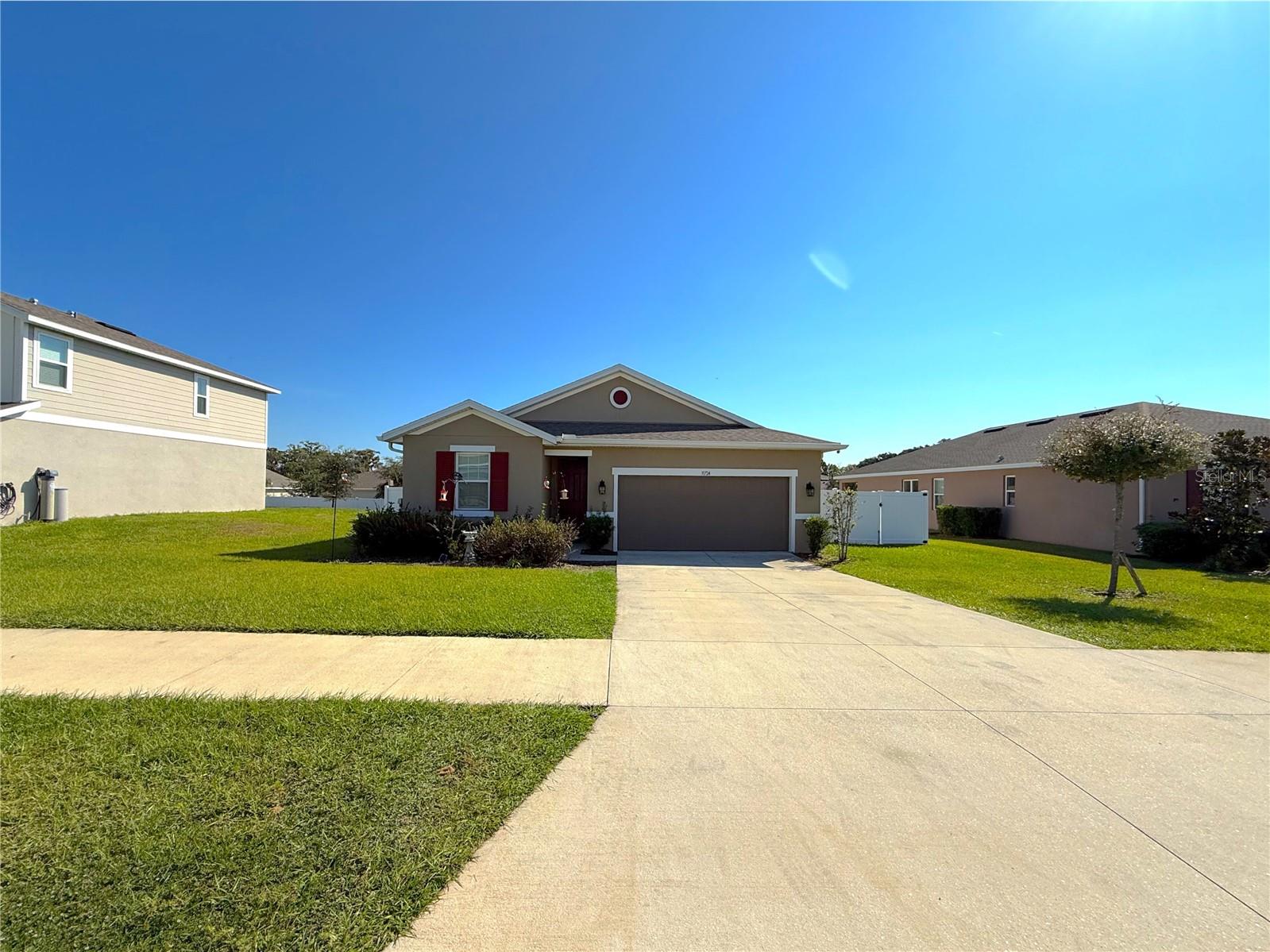 Experience modern comfort and low-stress living in this bright, open-concept home built in 2022. Designed for convenience and peace of mind, this residence has been meticulously maintained, with A/C serviced twice a year and a whole-home water filtration system already in place.
Enjoy the spacious flow of natural light, tile flooring throughout, and recessed lighting that enhances every space. The kitchen features elegant granite countertops, beautiful cabinetry, and all appliances included, plus a washer and dryer for added ease. Each room offers ceiling fans, and the fenced yard provides privacy and security.
Technology and safety are covered with fiber optic internet, a transferrable ADT alarm system, and fire extinguishers installed for your protection.
Located outside of any flood zone, this home offers access to multiple nearby lakes perfect for water sports, as well as smooth greens at several golf clubs. You’ll also find Leesburg International Airport just minutes away, offering general aviation, private jet access, and flight schools.
Perfectly positioned near Highway 441, you’ll have easy access to Orlando, Tampa, and all the local charm of a quaint community—including cultural events and vibrant farmers markets.
This home blends modern convenience, tranquility, and a true low-stress lifestyle.  Ready for you to move right in!