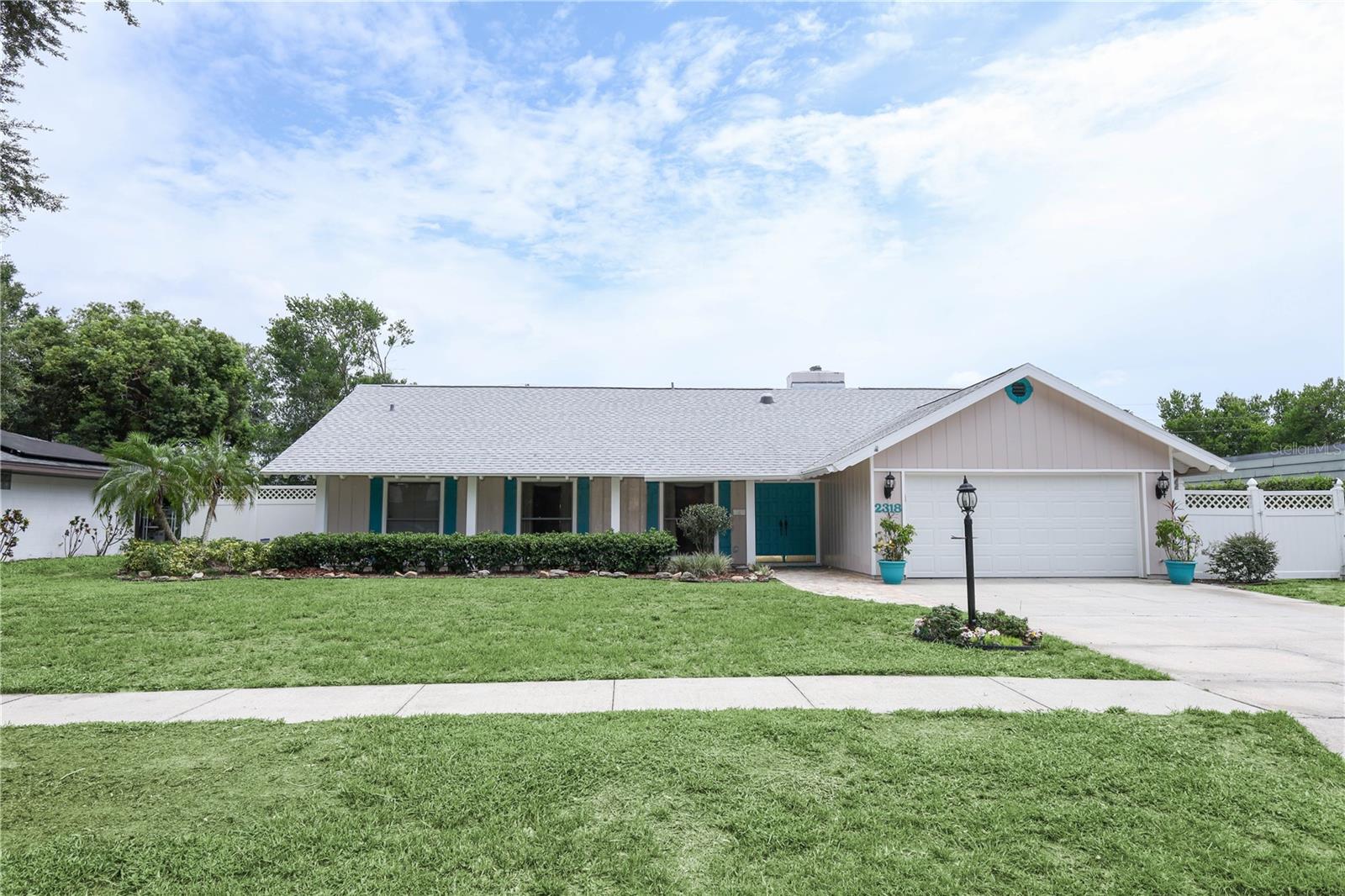 You know it is your house as you walk on your cobblestone to your front porch. As you enter the wide double doors they beckon you inside. This is your Ruttenberg floor plan home which is designed for both comfort and style.
Heart of the Home: The Kitchen At the center of the home, the kitchen has been thoughtfully updated with solid wood cabinets, a functional working island, ample drawer space, and a spacious pantry. The cozy eat-in nook overlooks your cobblestone-surrounded, screened-in pool, creating a perfect spot for morning coffee or casual meals.
Living Spaces The family room opens easily, featuring a charming brick fireplace with an electric crackle for ambiance. Three additional bedrooms are thoughtfully arranged, including a pool-planned bathroom and a secondary ensuite bath for guests or family.
Formal Living & Dining An L-shaped formal living and dining room divides the home, offering elegant spaces for entertaining or relaxing.
Primary Suite Retreat The updated primary suite is a true retreat, featuring a private water closet, step-in shower, double sinks, and double closets. Wide doors throughout make movement easy and accessible.
Convenience & Extras Laundry facilities are conveniently located on the way to the two-car garage, where you’ll also find a carbonated water filter just outside the door for fresh, sparkling water.
Outdoor Living For those who love the outdoors, the large cobblestone deck wraps around the screened-in pool, providing plenty of space for entertaining year-round. There’s a fire pit in the backyard to enjoy.