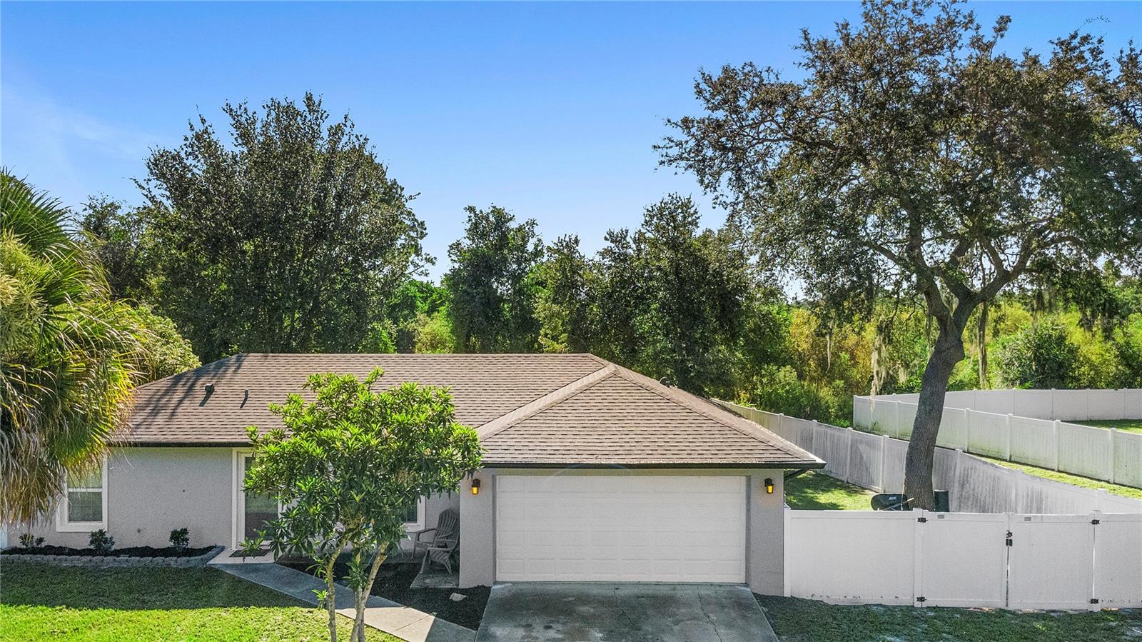 This well-kept split floor plan home has been thoughtfully remodeled with modern touches inside and out. A newer roof (2021) enhances the fresh grey exterior, complete with upgraded gutters and leaf guards. Inside, the living room welcomes you with updated lighting, ceiling fans and brand-new laminate wood flooring throughout for both style and easy maintenance. The kitchen blends function and design with grey cabinetry, granite countertops, stainless steel appliances, a motion-sensor faucet and a spacious closet pantry. The breakfast nook opens through French doors to a large screened-in porch featuring new epoxy flooring and recently added electrical outlets perfect for entertaining or relaxing. From there, enjoy the view of a fully fenced backyard (2019) with dual gates and plenty of space to make your own. Both bathrooms have been tastefully updated, including a full bath in the guest bathroom and a walk-in tiled glass shower in the primary suite. The primary bedroom also offers a generous walk-in closet. A two car garage provides ample parking and a convenient laundry area. Perfectly located between Orlando’s entertainment and Florida’s beaches with shopping, schools, medical offices and parks nearby. This home combines comfort, privacy and everyday practicality. Schedule your showing today!