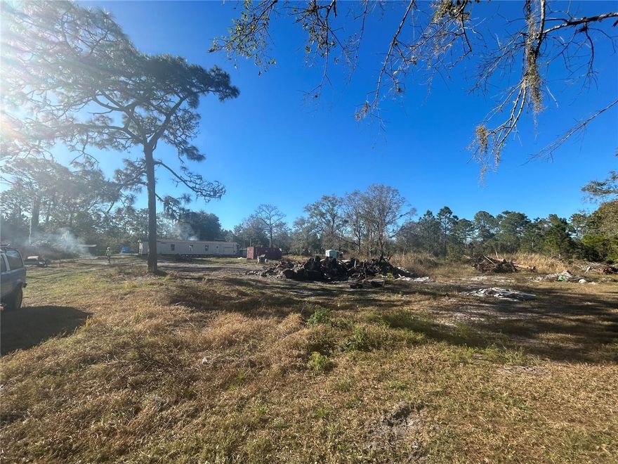 PRICED TO SELL! Just under 1 acre in Holopaw with the IMPACT FEES PAID!, a well on the property, and cleared land ready to go! The existing mobile home is a full renovation or tear-down—perfect for building new and making it your own or a place to store your toys! Located near Suburban Estates with access to nearly 11,000 acres of recreational land for ATV riding, four-wheeling, mudding, and endless outdoor fun! Build your dream home or create the ultimate spot for your toys and weekend adventures. Motivated seller!