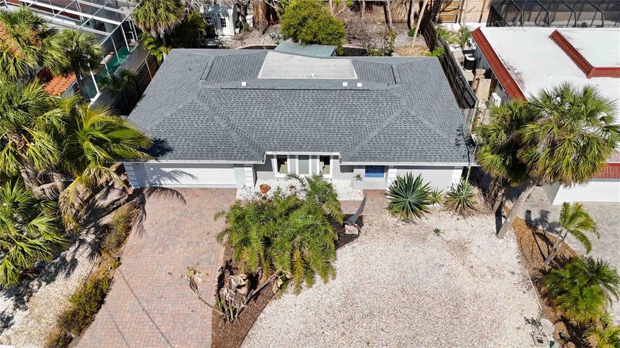 Located in the heart of Siesta Key, this three-bedroom, two-bath home with a two-car garage offers a rare opportunity to experience island living just one mile from Siesta Key Beach—consistently ranked the #1 beach in the United States for its white quartz sand, turquoise waters, and year-round appeal.
This property is perched on an elevated lot that has never experienced flooding. Recent updates in 2025 include a new roof, fresh landscaping, exterior lighting, and updated exterior paint, enhancing both aesthetics and durability.
Inside, the home is designed for comfort and functionality. The living room is bright and open, with large windows to bring in natural light. The kitchen offers a well-planned layout with an oversized island, wood cabinetry, stainless steel appliances, wall oven (2025), and granite countertops—creating a versatile space for cooking, dining, and entertaining.  The dining room overlooks a screened-in lanai and a landscaped backyard, through three large sliding glass doors creating a seamless indoor-outdoor flow.
The primary suite includes tall windows overlooking the serene backyard, a spacious walk-in closet, an en-suite bath with dual sinks, and backyard views. A split floor plan provides privacy, with two additional bedrooms connected by a Jack-and-Jill bathroom. Additional features include a spacious dedicated laundry room, a two-car garage, a reverse osmosis filtration system(2018), water heater(2023),  A/C system (2019), perma-lined pipes(2020), gutters, a shed, and fenced yard.
The backyard is a peaceful retreat, with a winding paver path through the garden, multiple seating areas, fountains, and an outdoor shower—an ideal space for relaxation after a day at the beach.
Siesta Key offers an active and vibrant lifestyle, with several public beach accesses, nearby pickleball and tennis courts, parks, playgrounds, and sports fields. Top-rated restaurants, boutique shopping, entertainment, and luxury spas are just minutes away.
This move-in-ready home is an invitation to embrace the best of Siesta Key. Schedule your private showing and receive additional information today.