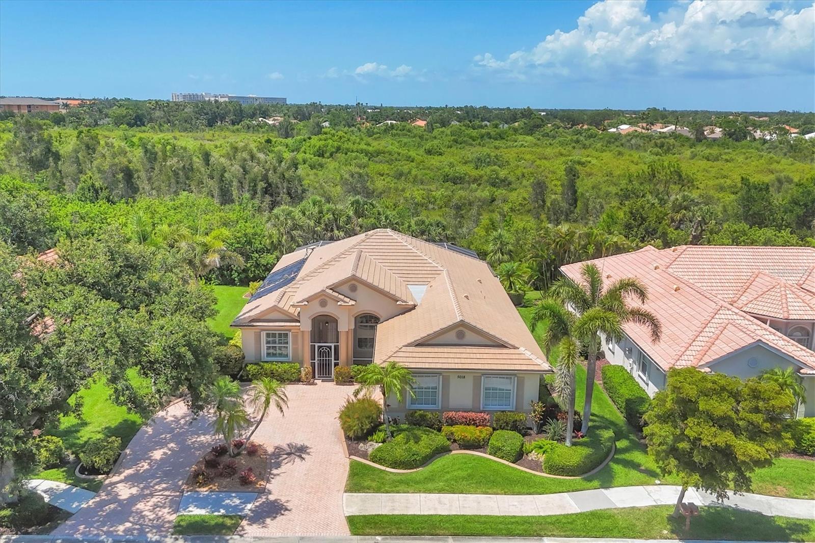 NEW and IMPROVED PRICE! Exquisite residence in a distinguished gated community. Don't let this 2 bedroom stop you from previewing this stunning home, the custom DEN/STUDY can serve as a third bedroom based on your family needs or overflow guests. Nestled in the secure and desirable gated community of Venetia, this meticulously maintained residence offers an unparalleled living experience defined by luxury, comfort and cultivated design. Boasting a surplus of upgrades and improvements, this solar-heated pool home presents a rare opportunity to acquire an exceptional property. The home's exterior exudes timeless elegance, enhanced by a newly painted facade, a new tile roof with an integrated rain gutter system and a gracefully circular driveway. Equipped with comprehensive hurricane shutters on all windows and doors, along with upgraded Pella insulated windows, residents can enjoy peace of mind and energy efficiency. Enter to discover a haven of refined living spaces. The interior has been thoughtfully remodeled, featuring new porcelain tile and laminated wood flooring throughout, complemented by designer lighting fixtures and fans. Coffered ceilings add architectural interest and grandeur to the living areas. Plantation shutters and custom drapery adorn the windows, providing privacy and an added layer of elegance. The heart of the home lies in its beautifully remodeled kitchen, showcasing granite countertops and premium appliances. Both the kitchen and baths have been lavishly updated with meticulous attention to detail. A custom-built study, complete with bespoke wood cabinets, an integrated desk and elegant glass French doors, provides an ideal space for work or quiet contemplation. The home features zoned cooling and heating system, ensuring optimal comfort throughout the year. Go outside to discover a private backyard oasis, complete with a resurfaced pool featuring new solar panels for efficient heating and a new pool pump. The screened-in front door enclosure allows for enjoying refreshing breezes while maintaining security and privacy. This exceptional property represents a harmonious blend of luxury, functionality and peace of mind. It is ideally suited for discerning buyers seeking a move-in-ready home with unparalleled amenities and a prime location in a secure and desirable community. Included with the sale are 6 TVs, 2 soundbars, all patio furniture, and work bench and tools. Schedule your private showing today and make this your next home!