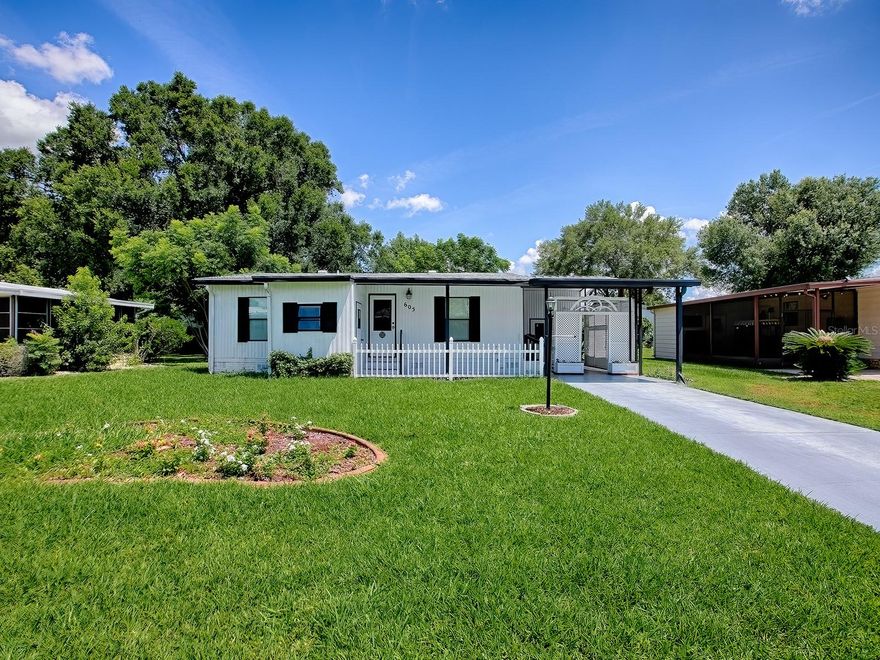 Reduced and owner is motivated! Welcome to The Villages at the Village of Silver Lake!   This 2 bedroom 1 1/2 bath home offers a separate living area and in-kitchen dining area. Covered south-facing front porch.  The removable beautiful trellises at the entrance to carport make for charming curb appeal and create a tranquil, private, shaded, east-facing outdoor area, the perfect place for your morning coffee.  The home has laminate flooring throughout the common areas, linoleum in the bathrooms, and carpeting in the bedrooms. The half bathroom is off the master bedroom.  The nearby full bathroom is easily accessible to the master bedroom, the guest bedroom and the main living area.  Brand new Owens Corning shingle roof in November 2020, brand new water heater in May 2025, and brand new HVAC with all new ductwork in February 2025.  The home comes with a paid 13-month home warranty for the new owners. This is affordable Florida living in a desirable golf course community. You will be minutes from dining, medical, shopping and plenty more. This location provides easy access to the convenient Shay Gate and is just across the golf cart bridge from Spanish Springs Town Square with its free nightly entertainment. Just minutes by golf cart from nearby Silver Lake Golf Course.  Lake Sumter Landing Town Square and four additional golf courses are only a short golf cart ride away.   Walk to the Southside pool, hot tub and rec center just one block away!