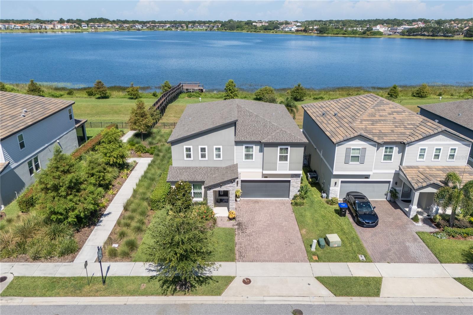 Stunning Lakeview 5-Bedroom Home in the Heart of Orlando- Sand Lake Sound.
Experience modern elegance and breathtaking lake views in this 5-bedroom, 4-bathroom home located in the heart of Orlando. The main floor features one bedroom with a full bath, while the upstairs boasts a luxurious master suite along with three spacious guest bedrooms and a large loft—ideal for a game room, media center, or second living space. Luxury vinyl flooring flows throughout the entire home. The stunning gourmet kitchen boasts sleek stainless steel appliances, elegant quartz countertops, ample cabinetry and modern lighting create both functionality and style.
Relax on your screened-in patio and take in the panoramic view of the expansive sand lake. The home is perfectly positioned next to the community dock—offering peaceful sunsets—and directly across from the resort-style community pool.
The lakefront community of Sand Lake Sound, nestled between Big and Little Sand Lake, enjoy convenient access to popular shopping, dining, and entertainment. Walt Disney World, SeaWorld, Universal Orlando, and other popular Orlando area attractions are only a short drive away.
Don’t miss out on this opportunity to own this stunning lakefront home—schedule your private tour today!
