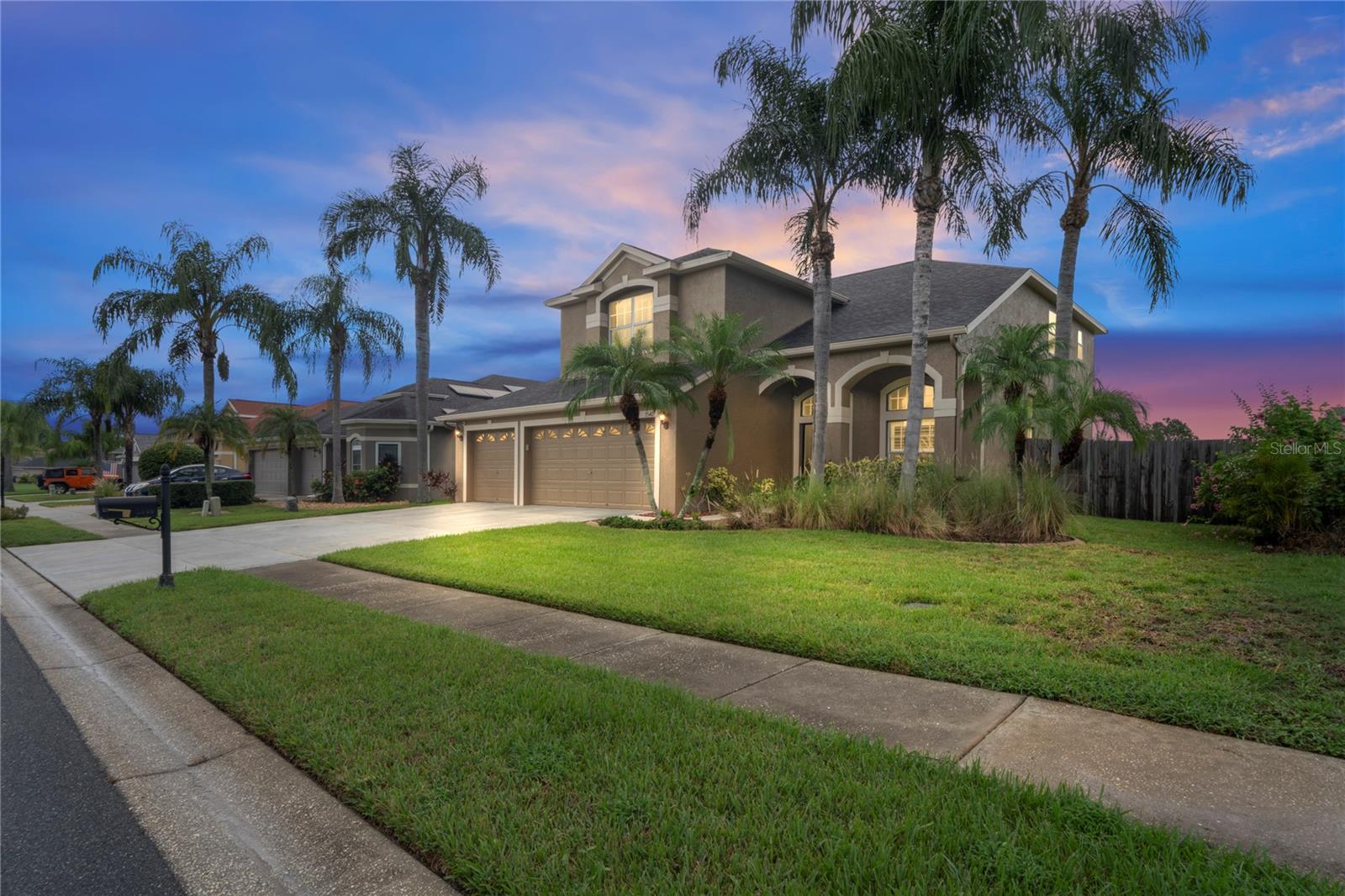 Welcome to your dream home in the highly sought-after PLANTATION PALMS GATED GOLF COURSE COMMUNITY! This vibrant neighborhood offers resort-style living with an AWARD-WINNING PAR-72 GOLF COURSE, clubhouse, The Palms Ballroom, and Mulligan’s Restaurant—perfect for leisure and entertainment right at your doorstep. This spacious 5-BEDROOM, 3-FULL BATH home with a 3-CAR GARAGE boasts nearly 2,800 SQ. FT. of living space on a ¼-ACRE LOT with a fully fenced backyard. Relax and entertain year-round in the impressive 680+ SQ. FT. COVERED AND SCREENED LANAI, ideal for gatherings or quiet evenings outdoors. The gourmet kitchen is a chef’s delight, featuring 42" WOOD CABINETRY, QUARTZ ZODIAC COUNTERTOPS, a center island, built-in wine rack, and TOP-OF-THE-LINE STAINLESS STEEL APPLIANCES. Upgrades and recent improvements provide peace of mind and modern style, including, tile and engineered hardwood flooring throughout (renovated in 2022). FRESHLY PAINTED EXTERIOR (2025). NEW ROOF AND WATER HEATER INSTALLED IN 2023. COMPLETELY REMODELED MASTER BATH in 2024. Additional highlights include: NO CDD FEES, proximity to top-rated schools, shopping, dining, and easy access to major highways. This home combines elegance, comfort, and convenience in one of the most desirable communities in the area—don’t miss your chance to make it yours!