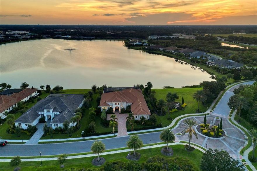 This spectacular custom-built Stock home sits on a large, unique lot on Lake Como.  Surrounded by lake and conservation areas, the home setting provides unusual privacy with neighbors on one side only ad a totally private lanai area.  Customer designed landscaping completely screes adjacent property.  Among the architectural details include coffered ceilings, tray ceilings and wall niches, and there are designer lighting fixtures, fans and wall coverings.  The view of the lake across the living room is enhanced by the disappearing sliding glass doors.  Adjacent to the living area is a formal dining area with dry bar.  A well-designed home office with custom cabinetry and built-in work areas covered with porcelain tile will be sure to please the most critical purchaser.  The stunning gourmet quartz kitchen with its two floating islands and informal dining area overlooking the lake has a large walk-in pantry, coffee bar, Sub-Zero and Thermador appliances, custom soft close cabinets and glass tile backsplash.  The great room, complete with custom cabinetry also has a spectacular panoramic private lake view through the two sets of slide away glass doors.  Step outside to the 3000 plus square foot shell stone lanai.  1200 square feet of the deck is under roof with high coffered ceilings, an area for watching TV with a ledgestone fireplace.  There is another area for outdoor dining adjacent to the outdoor kitchen.  In he uncovered area, the lanai extends to incorporate a beautiful saltwater pool with lap lane and spa. Two large separate sitting areas are at either end of the pool along with an enclosed pool storage room.  The large open floor plan designed with three bedrooms on one side, each with ensuite and custom walk-in closets.  On the opposite side of the home is a spacious master bedroom with coffered ceilings and overlooks the pool area.  There are two large walk-in closets and a master bath with double walk-in shower, soaking tub, and custom double vanities.  Last, but far from least, is an 800-bottle wine room that is fully insulated and refrigerated.  This home us for the truly fastidious purchaser who will not settle for something less than exceptional.