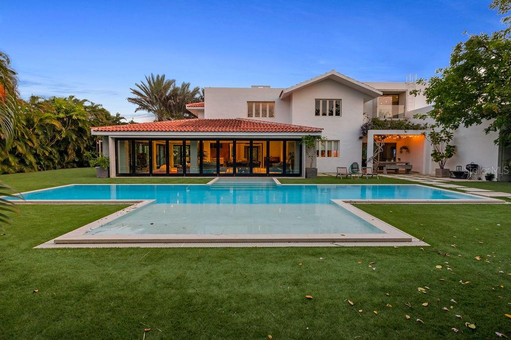 This luxurious 8,706 sq. feet property has 5 bedrooms, 6.5 bathrooms, two spacious living areas , modern, fully equipped kitchen, a great terrace, gas grill and outdoor furniture plus lounge chairs, and one 4 passenger golf cart. The house is 2-3 miles from the beach (less than 10 minutes in golf cart) and less than a mile from the Wellness and Tennis center, and Windmill Waterpark.
The Dorado Beach East community is private, gated, family friendly and offers a wide range of facilities that you can enjoy at no additional cost. The facilities include scenic pools, clay tennis courts, basketball and beach volleyball courts, a basic gym, a game room, a 3-par golf course that winds through the neighborhood, and an aviation themed park which has a custom water park and sand park.
Located within the Dorado Beach Resort, since it is a 2,000-acre natural reserve most of the communities are 1-3 miles away from the beach and Hotel. This being said, the entire resort is interconnected via golf cart trails, meaning that you can have easy access (walking or in golf cart) to the different communities and amenities within this Resort.
