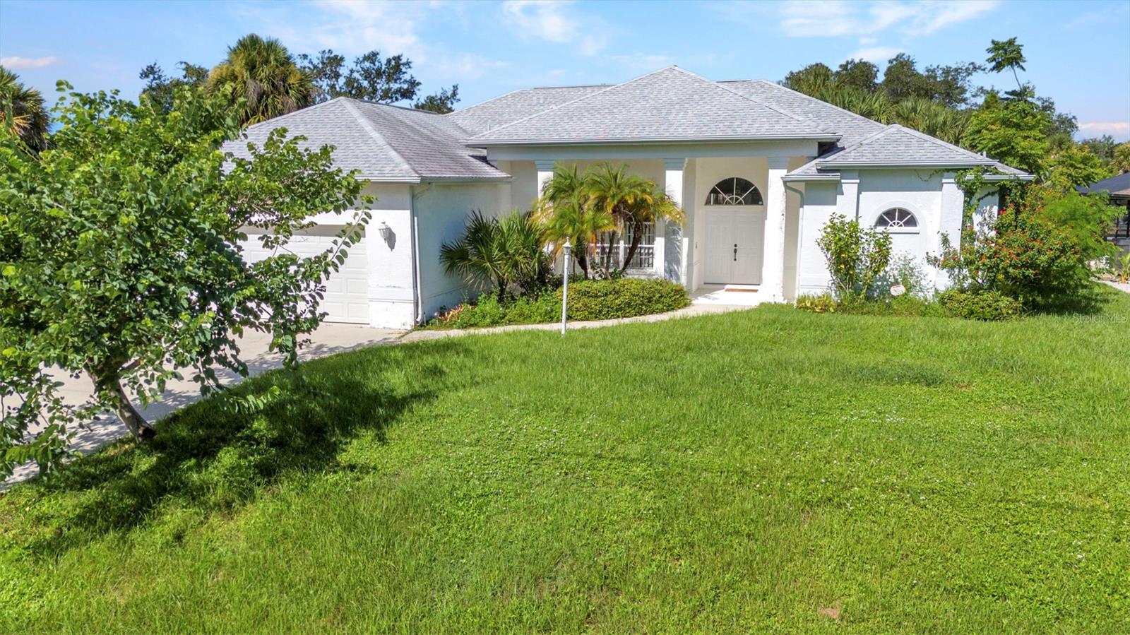One or more photo(s) has been virtually staged. Bring Your Vision to This Waterfront Pool Home! Discover your slice of paradise along the scenic Como Waterway with Gulf access! This spacious 3-bedroom, 2-bath, oversized 2-car garage home boasts over 2,100 sq. ft. of living space and a sparkling pool, perfect for year-round Florida living. Step through the French Doors into a bright, open formal living and dining area with soaring ceilings and pocket sliders that blend indoor and outdoor living effortlessly. Inside, you’ll find a mix of tile and carpet throughout. The kitchen is both functional and inviting, featuring ample cabinetry, plenty of counter space, a pantry, breakfast bar, and a cozy nook overlooking the pool and canal. A bonus family room offers extra space for relaxing or entertaining. The inside laundry room is equipped with a washer & dryer and utility sink. The primary suite opens directly to the pool and boasts two walk-in closet and spa-inspired bath with dual sinks, linen closet, a soaking tub, and a walk-in shower. Two spacious guest bedrooms share a bathroom with a single vanity and a walk-in shower. Step outside to enjoy your private pool and extended lanai, the ultimate Florida lifestyle —ideal for hosting or unwinding while taking in serene canal views. With 80 feet of concrete seawall there is plenty of room to add a dock and boat lift, this is truly a boater’s dream. Recent updates include: Roof (2018) and Garage Door (2021). Conveniently located near shopping, dining, and Gulf beaches. Don't miss the chance to make this waterfront paradise your own. This home is ready for your personal touch—schedule your private showing today and imagine the possibilities!