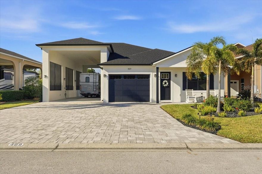 This home is move in ready!  If you are looking for the perfect winter getaway or ready to move to sunny Florida than this is the one.  Located in the sought after community of Mt. Olive Shores North, an upscale RV community.  This home was built in 2023 with high end finishes and is in spectacular condition.  With a second bedroom and bathroom for guests to enjoy some privacy when visiting.  The primary bedroom and bathroom are conveniently located towards the back of the home.  The laundry room is located in the primary suite for convenience.  Sliding glass doors give you a beautiful view to the patio area from both the living room and the primary bedroom.  With the sliding doors completely open the size of your entertaining space just doubled.  The RV port is extra wide with plenty of room to park your motorhome and an additional vehicle or golf cart.
Call today for an appointment to see this beautiful home.