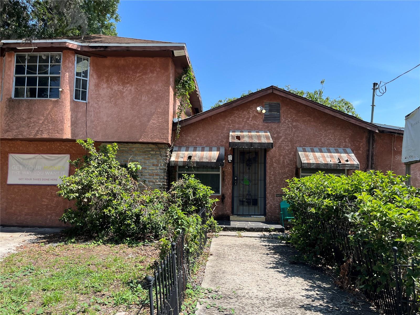 VALUE IN THE lAND Koi pond and outdoor grill around back. Vaulted ceilings. Skylight. Two bathrooms (1 upstairs, 1 downstairs). Half block off Florida Ave. Two blocks North of Sligh. LIVE AND WORK IS POSSIBLE.