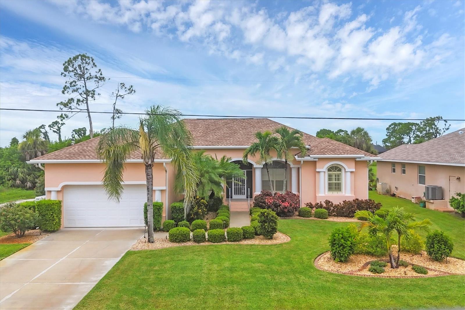 INTRODUCING - Meticulously and continuously maintained, 4-bedroom and 4-bathroom custom home, located in popular Rotonda West, Florida, surrounded by GOLF and a 15-minute ride to the sparkling blue water of the GULF. The kitchen and the pool area are immense, and the heart of this home. The kitchen takes center stage, at 15 x 19, with both an island and a large breakfast bar that offers seating for six. It features granite counter tops, a step-in pantry, and cabinets galore! It also offers a perfect eating area with a picturesque aquarium window, built-in cedar benches for storage, and custom window treatments. The back yard is a perfect, private sanctuary with an expansive screened pool area. The spacious lanai has a built-in grill area, gas fire pit and gas lamp posts, creating an elegant and unique effect. Tropical foliage surrounds you in the heated saltwater pool and spa. The whimsy striped, remote awning (with led lighting) offers extra shade when needed. The pool area also offers its own full bath with walk-in shower! Two of the four bedrooms are master ensuites with soaking tub, separate showers, and dual vanities. 2 additional bedrooms, a separate dining room, front parlor, family room, interior laundry room (with shelving, utility sink and closet) make this a perfect home for your family, guests or an investor. The home has been professionally landscaped with outdoor lighting, has a new roof, an irrigation system that uses both well and public water (well water on the grass and public water near the home and driveway to keep it clean), a 2-year old whole home generator, clear and accordion hurricane shutters, gutter guards, two young AC systems, sliding and french doors, plantation blinds, and a two car garage with a large, level driveway that fits 4 cars. This home easily sleeps 8 people and has plenty of roaming space both inside and out. It has been loved and enjoyed and is looking for its new owner. If you love a spacious kitchen and you love a gorgeous outdoor space, this home is a MUST-SEE.