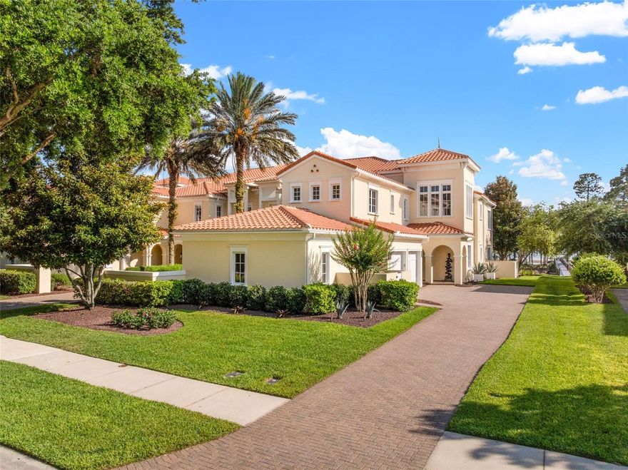Experience elevated lakefront living in this beautifully reimagined 3,081-square-foot ground-floor condominium overlooking the tranquil waters of Lake Nona. Located within the highly sought-after Lake Nona Golf & Country Club, this fully updated 3-bedroom, 3.5-bath residence combines timeless luxury with a warm, inviting feel that truly makes it feel like home. From the moment you walk in, sweeping lake views and natural light draw you into the open living spaces. Marble floors run throughout the home, while thoughtfully selected designer lighting and custom finishes add character and sophistication at every turn. A stunning sitting area with a dramatic marble accent wall and sleek firebar creates an unforgettable focal point, flowing effortlessly into the family room with custom built-ins designed for both beauty and functionality.
The kitchen is striking yet incredibly functional, featuring floor-to-ceiling cabinetry, marble countertops and walls, and a coveted La Cornue induction range that anchors the space. Every detail was carefully chosen to create a kitchen that feels both luxurious and livable.
The primary suite is a true retreat, complete with a statement chandelier, designer wallpaper feature wall, and two custom closets. The spa-like bath has been completely renovated with a steam shower, beautiful tilework, designer fixtures, and custom cabinetry that offers exceptional storage without compromising style. Each secondary bedroom features its own fully renovated en-suite bath, all finished with the same level of quality and attention to detail found throughout the home. Custom closet systems in every room provide effortless organization and generous storage. Even the laundry room has been thoughtfully redesigned, reflecting the care and craftsmanship that went into every inch of this residence. Outside, the covered patio with a motorized screen creates the perfect place to relax and enjoy peaceful lake views year-round, seamlessly blending indoor and outdoor living. Additional features include a private garage and a convenient powder bath for guests. This home has been completely transformed with exceptional attention to detail and truly feels move-in ready in every sense. Elegant yet comfortable, polished yet welcoming, every space was designed to be both beautiful and enjoyed. 
Residents of Lake Nona Golf & Country Club enjoy access to world-class amenities including championship golf, fine dining, a wellness center, and an active social calendar, all within one of Orlando’s premier guard-gated communities. Also, enjoy access to your own private dock on Lake Nona as a coach home owner. This dock is exclusive to the 20 coach home unit owners and is a special location to relax, read or have celebrations and gatherings with family & friends! This is more than just a beautiful home, it’s a lifestyle. Nestled within the gated Lake Nona Golf & Country Club, residents enjoy 24-hour security, A-rated schools, and close proximity to Orlando International Airport, Medical City, Boxi Park, fine dining, shopping, and major expressways (417 Greenway and 528 Beachline) for convenient access throughout Central Florida. This move-in-ready home perfectly blends timeless craftsmanship, elegant updates, and the very best in Country Club living. Both HVAC units 2025, Water Heater 2024, Garage Doors 2024, 2 EuroCave, 200-bottle capacity Wine Coolers and so much more!