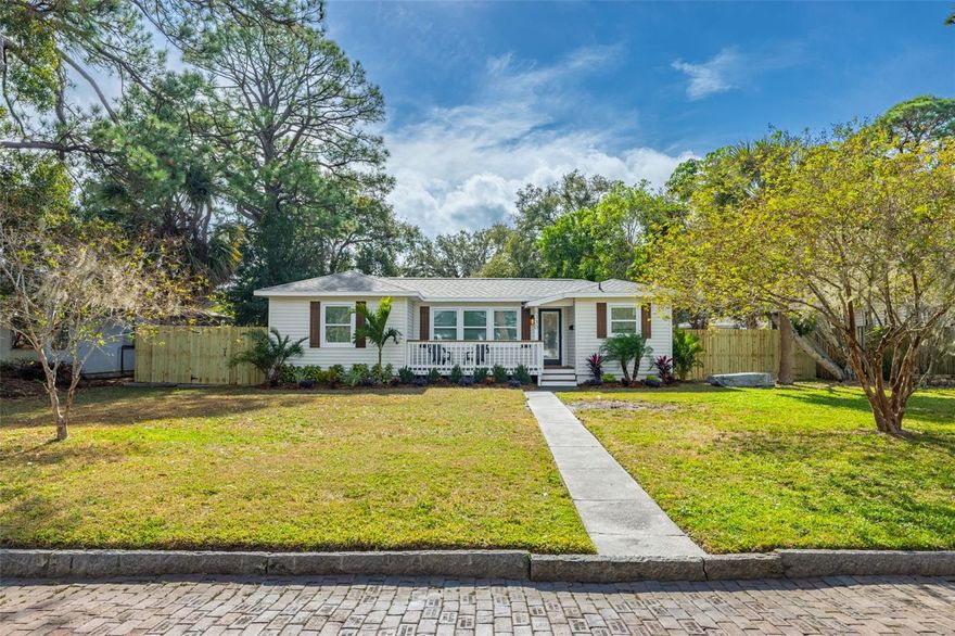 Welcome to this beautifully renovated three bedroom, two bathroom home ideally located at 6330 3rd Ave N in the heart of St. Petersburg. Perfectly positioned outside of a flood zone, no flood insurance is required, yet you are still just ten minutes from the sugar sand and sunsets of St. Pete Beach. Major updates have already been completed, including a new roof, new windows, a new AC system, and a new electrical panel, offering peace of mind for years to come.

As you arrive, you are welcomed by excellent curb appeal along this charming brick lined street. A quaint front porch and all new landscaping frame the home beautifully, setting the tone for what awaits inside. Step through the front door and you will immediately notice that no expense was spared in this renovation. Luxury vinyl plank flooring flows throughout the home, creating a cohesive and modern feel.

The kitchen is sure to impress with quartz countertops, stainless steel appliances, a stylish backsplash, and floating shelves that add both function and design. The owner’s suite is generously sized and features a stunning ensuite bathroom with a modern vanity and a walk in shower finished with floor to ceiling tilework. The guest bathroom mirrors the same elevated finishes, maintaining a polished and thoughtful design throughout the home.

Make your way out back to discover a large deck that is perfect for entertaining or relaxing, overlooking an expansive fully fenced backyard. An alley behind the property provides access to convenient fenced backyard parking with a pavered driveway. With plenty of room for pets to run freely or to create the outdoor oasis of your dreams, this backyard offers endless possibilities.

This location truly shines, offering quick access to St. Pete Beach, downtown St. Petersburg, Tyrone Square Mall, local parks, dining, and shopping. Commuters will appreciate the easy access to major roadways, while beach lovers will enjoy being just minutes from the Gulf. Zoned for A rated Azalea Elementary, this home checks all the boxes for location, updates, and lifestyle. Schedule your showing today before this one is gone.