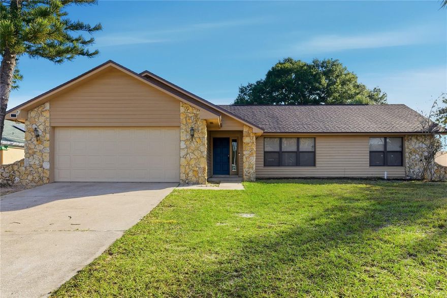 Beautiful home on expansive half-acre lot and NO HOA! Welcome home to this inviting 3-bedroom, 2-bathroom single-family residence located in a residential area right off University Blvd. Step into a bright living space with vaulted ceilings throughout, creating an airy, open feel from the moment you enter. The front living room offers a welcoming first impression and leads into a formal dining room. The kitchen sits at the heart of the home, featuring granite countertops, stainless-steel appliances, cabinetry, and an eating space, right off the kitchen. Next to the kitchen is a cozy family room with a wood-burning fireplace and sliding glass doors access to the backyard. This split floor plan provides privacy, with the primary suite positioned separately from the secondary bedrooms. The primary bedroom is generously sized, windows for natural light, along with a walk-in layout and a beautifully refreshed bathroom featuring dual vanities and  cabinetry. Enjoy Florida living year-round in the screened-in back patio, perfect for relaxing. The outdoor space is a major highlight!! An oversized, half-acre fenced yard with endless potential: pool, garden, playground, or pets. Wide-open green space offer privacy and room to roam. No HOA means flexibility. *Roof replaced in 2022. Water heater replaced 2 years ago. Fresh interior paint.* Inside laundry room for convenience. Ideally situated near University Blvd and 417, just minutes from UCF. Short drive to Orlando International Airport, and Downtown Orlando. Everyday essentials are moments away with Publix shopping centers, restaurants, cafés, and quick-service dining nearby. This home blends comfort, space, and convenience with a rare oversized homesite. Call us today for a private showing!