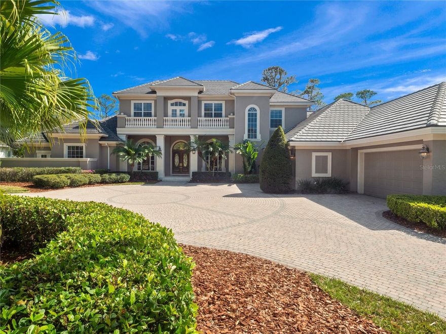 Nestled in the sought-after guard gated community of Alaqua Lakes, this exquisite 7,692 SF golf-front estate in the exclusive and gated Reserve offers ultimate privacy with a double-gated entry and a prime location on the 9th fairway just steps from the Legacy Golf Course clubhouse, driving range and putting greens.  Perfectly positioned on a quiet cul-de-sac, this grand abode with newer roof (2021) offers the best of Florida living...inside & out! Beyond the grand double doors you are greeted with views of the sparkling pool and golf course, soaring ceilings and lots of natural light that fills the formal living and dining space to warmly welcome your guests.  This home features a recently updated oversized gourmet kitchen with striking Cambria Brittanica quartz countertops, honed marble backsplash, solid wood cabinets, updated high-end appliances, a butler’s pantry with matching Cambria Brittanica quartz tops, a huge pantry and a breakfast nook. Enjoy cool days by the beautiful double sided natural gas cast stone fireplace with views of the pool and golf course.  Built for effortless entertaining, the residence boasts abundant first-floor common space including a recently redesigned family room with light wood accents, designer lighting and sliders that open to the lanai.   The spacious game room is just through double doors and shares access to a centrally located bar with service windows, and a private theater room perfect for watching the big game or your favorite movie! The bar was just refinished with new Cambria Carrick quartz tops, a beverage fridge and an ice maker.  The first-floor primary suite is a true retreat, offering a private sitting area, dedicated workout room, his-and-her walk-in closets, a spa-inspired bath with a garden tub, and a private verandah.  A stately home office with custom built-ins and a statement window plus a powder bath for your guests with pool access completes the primary wing. Also on the first level are two additional bedrooms with a Jack-and-Jill bath updated in 2019, a dedicated study area with new Sonata quartz tops, a wine cellar and an expansive laundry room with center island, while the second floor features three more bedrooms, two baths, and a bonus space with built in desk perfect for a dedicated study room, craft room or climate control storage!  The outdoors are just as impressive with brick paver motorcourt which leads to an oversized 4 car garage.  The impressive 22,000 gallon pool with fountain and water features, a built in table and a swim shelf is set aside a generous covered lanai for fun in both the sun and shade on beautiful Florida days.  Cookouts are a breeze with the service windows from the bar and a built in natural gas grill.  Set in one of Central Florida’s most elite communities, residents enjoy access to Alaqua Lakes’ premier amenities, including a clubhouse, 7-acre park, junior Olympic pool, Har-Tru tennis courts, beach volleyball, basketball courts, multipurpose ball fields, a playground, and exclusive social events. Alaqua Lakes is a natural gas community.  Offering the best of Florida living inside and out, this estate is a testament to refined elegance and world-class lifestyle—an address reserved for those who expect nothing but the best.