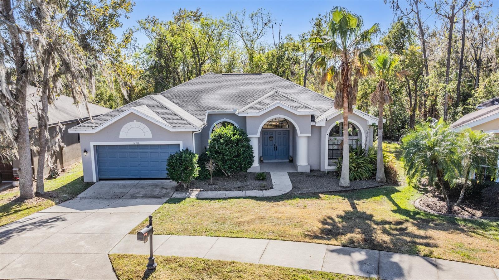 Welcome to Casual Elegance in the highly desirable, GATED community of Lake Jovita Golf and Country Club, where luxury living meets everyday comfort. Situated on a premium conservation lot, this thoughtfully updated 4-bedroom, 2.5-bath, 2-car garage home offers privacy, serenity, and impressive upgrades. As you approach, you'll notice the charming concrete front patio and elegant double front doors, which open into a spacious, single-level floor plan filled with natural light and designer details. Arches, niches, accent walls and Recent upgrades include a newer Roof (2022), luxury vinyl plank flooring throughout the home, a fully remodeled kitchen with two-tone cabinetry, granite countertops, stainless steel appliances, glass tile backsplash, pendant lighting, and a unique vintage tile floor. The open-concept layout features a large great room with an accent wall, welcoming foyer, dining room, and eat-in kitchen... ideal for entertaining plus everyday living. The owner’s suite is a true retreat, complete with a spacious bedroom, a spa-like bath with a soaking tub, double vanities, separate shower, and a custom walk-in closet featuring custom closet organizers. A stunning $20,000 window frames views of the tranquil conservation lot, bringing the outdoors in. The additional three bedrooms and a full bath provide ample space for guests, family, or a home office. A beautifully updated powder room features a glass accent wall, pedestal sink and floor-to-ceiling ceramic tile for an upscale touch. Step outside to enjoy your own peaceful sanctuary. The expanded screened-in lanai overlooks a wooded conservation area, offering complete privacy and the feel of a Zen garden—perfect for morning coffee, meditation or evening relaxation. A pool could easily be added in this space. The backyard includes a wooden deck with space for a firepit, making it ideal for outdoor gatherings. The garage has been upgraded with built-in cabinets, shelves and overhead racks, giving you plenty of storage space. Golf cart is negotiable, making it easy to enjoy the full Lake Jovita Golf and Country Club lifestyle. Located in The Preserve just a short distance to Saint Leo University... this home offers scenic surroundings with rolling hills that feel more like North Georgia or upstate New York instead of Florida! Lake Jovita is a premier, gated, resort-style community just 20 minutes from North Tampa, with easy access to major highways for easy commute to Orlando, Ocala, Tampa, Saint Pete, Airports and the Beaches. Optional memberships provide access to two championship 18-hole golf courses, a Junior Olympic-sized swimming pool, Har-Tru clay tennis courts, state-of-the-art fitness center, clubhouse and social events. Low quarterly HOA includes use of playground, dog parks and community walking trails with exercise stations, pickleball, tennis and basketball courts. This move-in ready home combines a serene natural setting with resort-style amenities, in one of Florida’s most picturesque and welcoming communities. Don’t miss your opportunity to experience the lifestyle you deserve... CALL TODAY!