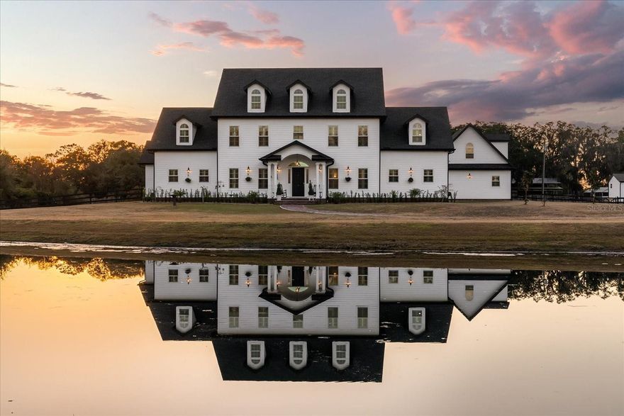 On nearly five acres of pristine land, this custom estate pairs thoughtful design with resort-level living and crafted for those who want room to breathe without sacrificing refinement.

A spring-fed pond welcomes you at the entrance and sets the tone for the calm, refined lifestyle inside. The home opens with soaring ceilings, sunlit rooms, and thoughtful craftsmanship throughout. The gourmet kitchen is the true centerpiece of the home, thoughtfully designed for both everyday living and elevated entertaining. It is complete with premium Wolf appliances, including two full-size Wolf ovens, a Wolf steam oven, and a Wolf microwave, along with dual farmhouse sinks, double dishwashers, and a generous ten-by-six island ideal for gathering and prep.
A sun-filled breakfast nook, expansive walk-in pantry, dedicated two-person study, and a spacious laundry room enhance both functionality and comfort, making daily living effortless in this exceptional space.
The Great Room flows to a covered outdoor living area through ten-foot accordion doors, revealing a resort-style saltwater pool, bubbling sundeck, and multiple cabanas. The first-floor primary suite feels like a private retreat with a spa-inspired bath featuring marble finishes, a soaking tub, quartz vanities, and a statement chandelier. An en-suite guest room, fitness room, powder bath, and additional storage complete the main level.

Upstairs offers four more en-suite bedrooms, a large game room, and a hidden home theater with a speakeasy vibe, complete with a 4K laser projector, 135-inch screen, immersive surround sound, and nine reclining leather seats.

The property also includes an attached garage apartment with a full kitchen, living area, and bath with its own private entrance. There is also a separate three-bedroom guest house with its own garage, ideal for multi-generational living or long-term guests. A large barn adds even more flexibility, whether for storage, hobbies, or a car collection. 

St. Cloud offers the best of both worlds: peaceful living with quick access to world-class healthcare, dining, shopping, and major travel corridors. 4510 Packard isn’t just a home. It’s a lifestyle.