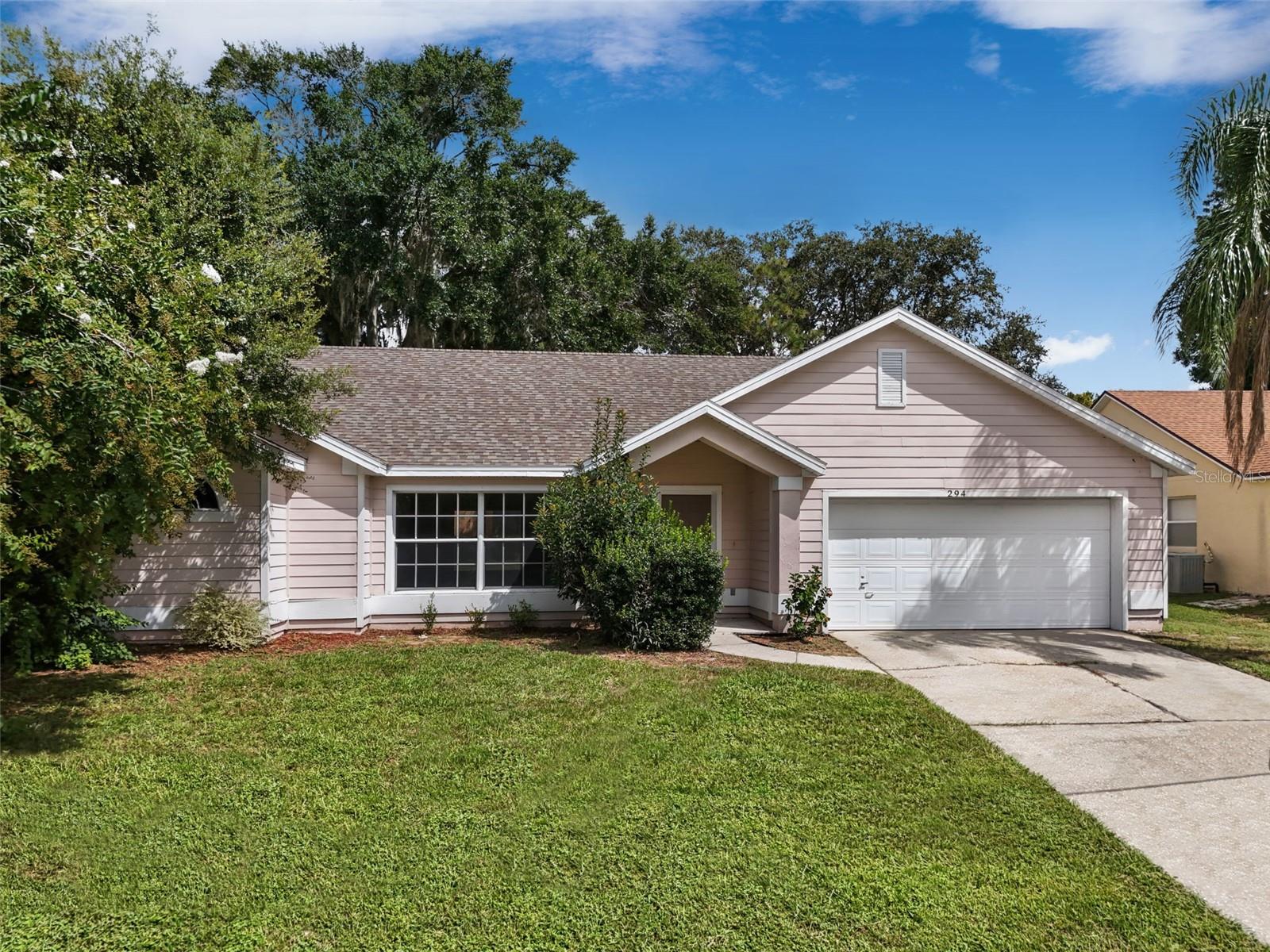 Welcome to 294 Lake Doe Blvd in Apopka! Zoned for highly sought-after and top-rated schools- Apopka Elementary, Wolf Lake Middle, and Apopka High. You’ll enjoy a prime central location, close to everything Apopka and Orlando has to offer. Featuring an updated roof, all-new luxury vinyl plank flooring, and fresh interior paint, this move-in ready home blends comfort, style, and convenience in one beautiful package.
Situated in the desirable Lake Doe community, surrounded by high-value lakefront homes, this 3-bedroom, 2-bathroom block construction residence offers 1,687 sq. ft. of well-designed living space on a spacious lot with low HOA fees. Inside, you’re welcomed by vaulted ceilings that create an airy, open feel throughout the main living areas and the primary suite. Large windows flood the home with natural light, while updated fixtures add a modern touch.
The split-bedroom floor plan ensures privacy, with the expansive primary suite tucked away and featuring direct access to the screened-in patio, perfect for morning coffee or unwinding in the evenings. The en-suite bathroom includes dual vanities, a soaking tub, and separate shower. Two additional bedrooms share a full bath, offering plenty of space for family, guests, or a home office.
The living and dining areas flow seamlessly, making entertaining a breeze. The kitchen offers ample counter space and storage, ready for your personal updates to make it truly your own. Step outside to the oversized screened patio overlooking the backyard, a blank canvas for gardening, play, or even a future pool.
Beyond your doorstep, Apopka delivers the best of both worlds: a peaceful suburban atmosphere with quick access to shopping, dining, and entertainment. You’ll also find beautiful parks, nature trails, and lakes nearby, as well as easy connections to major highways for commuting throughout Central Florida.
With its sought-after location, quality upgrades, and inviting layout, 294 Lake Doe Blvd is more than just a house, it’s the perfect place to call home. Schedule your private showing today and see for yourself why this is one of the most desirable opportunities in Apopka!