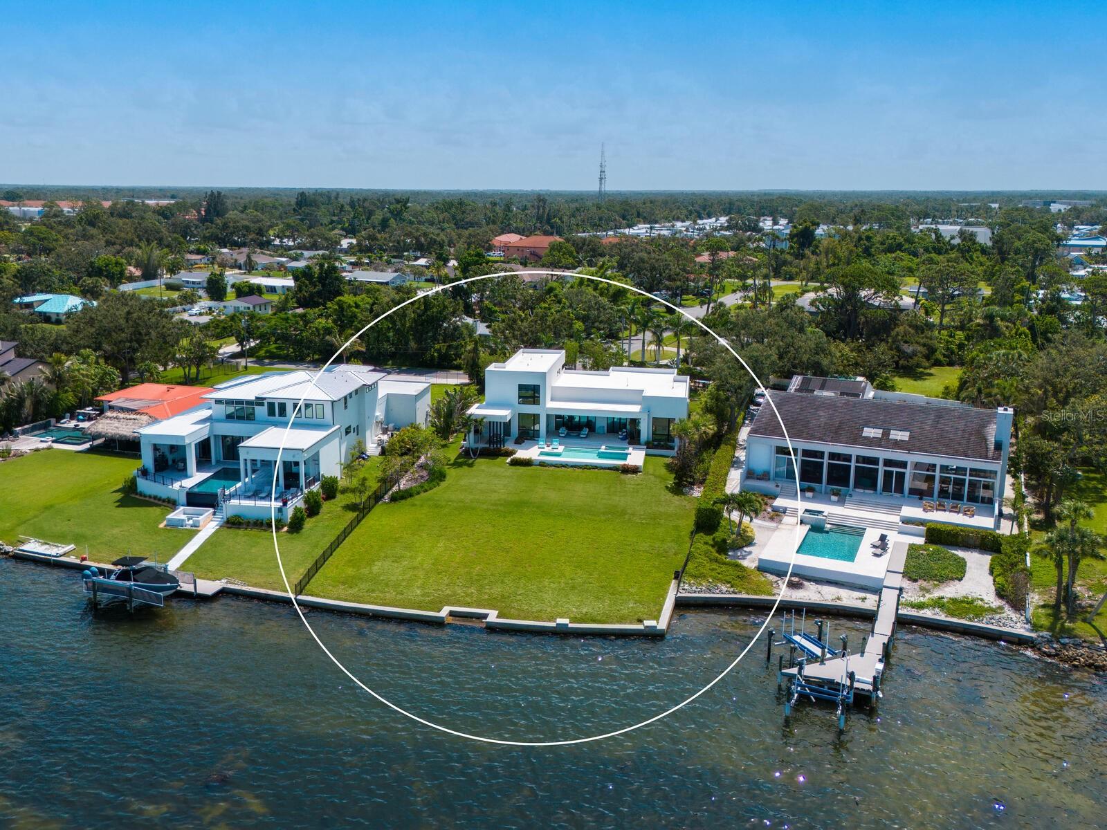 Welcome to 622 Bayshore Drive - where coastal luxury meets modern sophistication on one of the most sought-after stretches of Little Sarasota Bay. Tucked away on a rare and expansive .78-acre gated estate, this custom-built, contemporary masterpiece offers 90 feet of pristine waterfront, unmatched privacy, and a lifestyle defined by serenity, style and seamless connection to the water. Designed for those who crave the extraordinary, this six-bedroom, five-bath residence is a showpiece of elevated design and quality craftsmanship, built just three years ago with the finest materials and storm-resilient features. Boaters will delight in the direct bay access just minutes from Midnight Pass and the open Gulf - a true water lover's paradise. Step through the grand entrance and into a world of light, space and unobstructed bay views. The soaring 14-foot bifold glass wall in the great room opens fully to a spectacular lanai, inviting indoor-outdoor living year-round. Imagine entertaining here – sunset cocktails by the saltwater pool and spa, laughter echoing across the water and every moment framed by nature's beauty. At the heart of the home lies a chef's dream kitchen, anchored by an oversized 7'X8' waterfall edge island and outfitted with top-tier Wolf, Cove, and Sub-Zero appliances. A walk-in pantry with second refrigerator/freezer ensures effortless hosting and everyday convenience. This home is as strong as it is stunning: constructed entirely of block and stucco, equipped with Category 5 impact-rated windows and doors, and elevated above flood level - a rare combination that provides peace of mind and impressively low insurance premiums. A whole-house generator ensures uninterrupted comfort. With its expansive yard, and panoramic water views, 622 Bayshore Drive is not just a home- it's a legacy property. Perfectly positioned between Sarasota and Venice, it offers the best of both worlds: quiet natural beauty with easy access to world-class dining, shopping and culture. DON'T JUST VISIT PARADISE - OWN IT. Schedule your private tour of this extraordinary waterfront estate today.