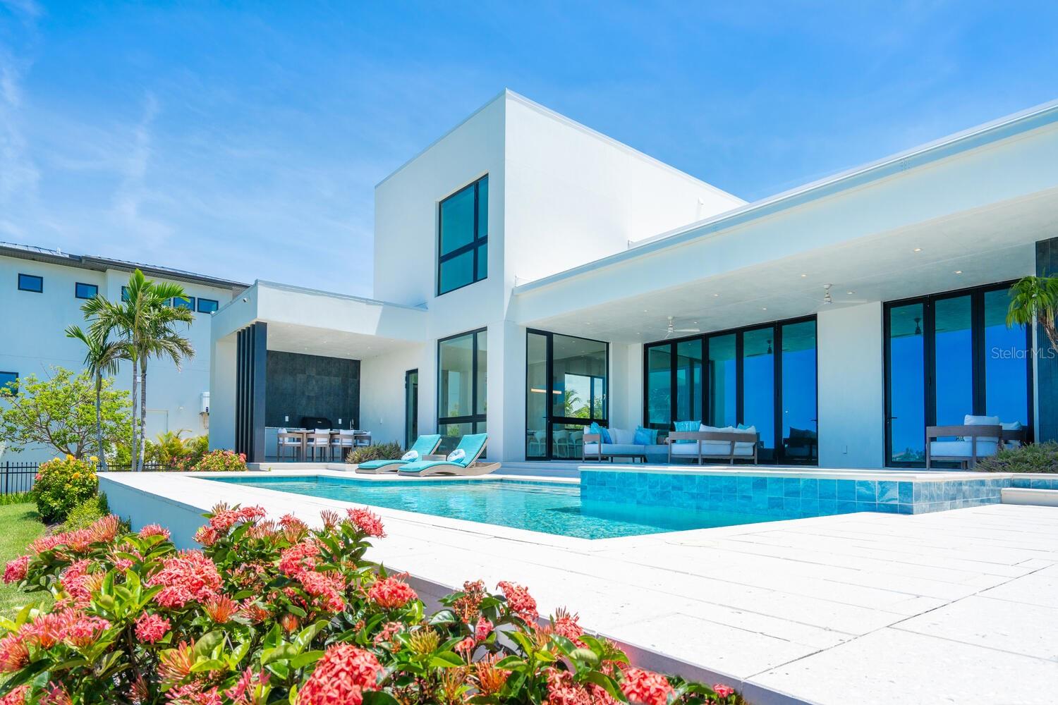ELEVATED ABOVE FLOOD LEVEL WITH EXCEPTIONALLY LOW INSURANCE PREMIUMS !
Welcome to 622 Bayshore Drive - where coastal luxury meets modern sophistication on one of the most sought-after stretches of Little Sarasota Bay. Tucked away on a rare and expansive .78-acre gated estate, this custom-built, contemporary masterpiece offers 90 feet of pristine waterfront, unmatched privacy, and a lifestyle defined by serenity, style and seamless connection to the water. Designed for those who crave the extraordinary, this six-bedroom, five-bath residence is a showpiece of elevated design and quality craftsmanship, built just three years ago with the finest materials and storm-resilient features. Boaters will delight in the direct bay access just minutes from Midnight Pass and the open Gulf - a true water lover's paradise. Step through the grand entrance and into a world of light, space and unobstructed bay views. The soaring 14-foot bifold glass wall in the great room opens fully to a spectacular lanai, inviting indoor-outdoor living year-round. Imagine entertaining here – sunset cocktails by the saltwater pool and spa, laughter echoing across the water and every moment framed by nature's beauty. At the heart of the home lies a chef's dream kitchen, anchored by an oversized 7'X8' waterfall edge island and outfitted with top-tier Wolf, Cove, and Sub-Zero appliances. A walk-in pantry with second refrigerator/freezer ensures effortless hosting and everyday convenience. This home is as strong as it is stunning: constructed entirely of block and stucco, equipped with Category 5 impact-rated windows and doors, and elevated above flood level - a rare combination that provides peace of mind and impressively low insurance premiums. A whole-house generator ensures uninterrupted comfort. With its expansive yard, and panoramic water views, 622 Bayshore Drive is not just a home- it's a legacy property. Perfectly positioned between Sarasota and Venice, it offers the best of both worlds: quiet natural beauty with easy access to world-class dining, shopping and culture. DON'T JUST VISIT PARADISE - OWN IT. Schedule your private tour of this extraordinary waterfront estate today.