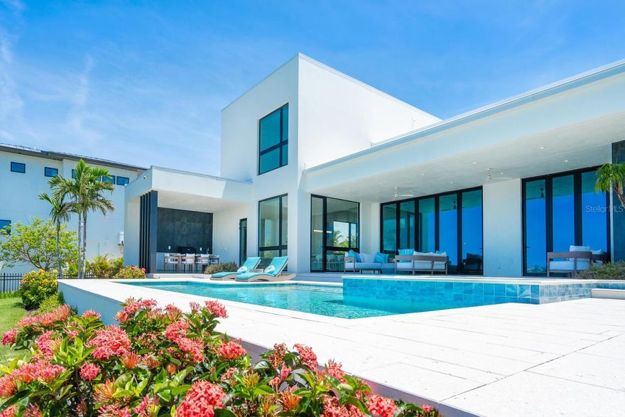 ELEVATED ABOVE FLOOD LEVEL WITH EXCEPTIONALLY LOW INSURANCE PREMIUMS ! 
Welcome to 622 Bayshore Drive - where coastal luxury meets modern sophistication on one of the most sought-after stretches of Little Sarasota Bay. Tucked away on a rare and expansive .78-acre gated estate, this custom-built, contemporary masterpiece offers 90 feet of pristine waterfront, unmatched privacy, and a lifestyle defined by serenity, style and seamless connection to the water. Designed for those who crave the extraordinary, this six-bedroom, five-bath residence is a showpiece of elevated design and quality craftsmanship, built just three years ago with the finest materials and storm-resilient features. Boaters will delight in the direct bay access just minutes from Midnight Pass and the open Gulf - a true water lover's paradise. Step through the grand entrance and into a world of light, space and unobstructed bay views. The soaring 14-foot bifold glass wall in the great room opens fully to a spectacular lanai, inviting indoor-outdoor living year-round.  Imagine entertaining here – sunset cocktails by the saltwater pool and spa, laughter echoing across the water and every moment framed by nature's beauty. At the heart of the home lies a chef's dream kitchen, anchored by an oversized 7'X8' waterfall edge island and outfitted with top-tier Wolf, Cove, and Sub-Zero appliances. A walk-in pantry with second refrigerator/freezer ensures effortless hosting and everyday convenience. This home is as strong as it is stunning: constructed entirely of block and stucco, equipped with Category 5 impact-rated windows and doors, and elevated above flood level - a rare combination that provides peace of mind and impressively low insurance premiums. A whole-house generator ensures uninterrupted comfort. With its expansive yard, and panoramic water views, 622 Bayshore Drive is not just a home- it's a legacy property. Perfectly positioned between Sarasota and Venice, it offers the best of both worlds: quiet natural beauty with easy access to world-class dining, shopping and culture. DON'T JUST VISIT PARADISE - OWN IT. Schedule your private tour of this extraordinary waterfront estate today.