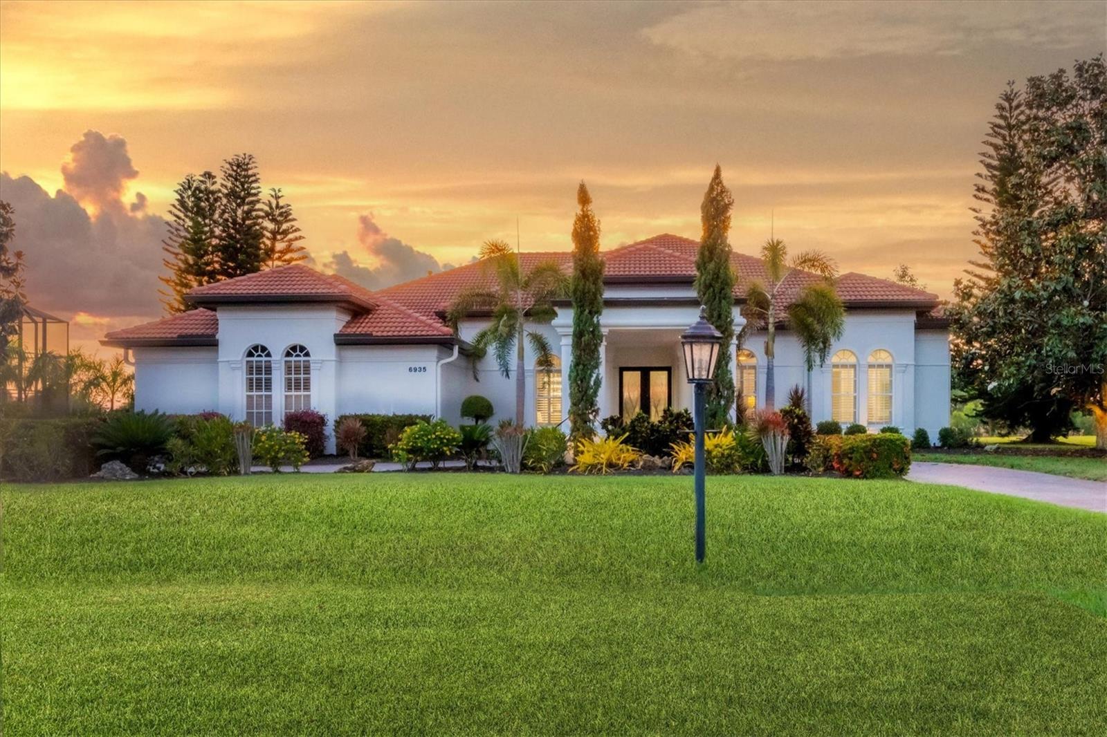 HIGH AND DRY WITH WHOLE HOUSE GENERATOR! Welcome home to 6935 Westchester Circle in the highly coveted neighborhood of Westchester in the gated community of Lakewood Ranch Country Club where golf club memberships are now available! This custom Arthur Rutenberg home sits on a more than a half-acre lot, with west facing backyard for sunsets every night! Roof, two Carrier HVACS, and water softener all replaced in 2018. Whole house generator was added in 2022. Hot water tank, outdoor lighting, interior paint, and exterior paint all added in 2020. Pool heater, multi-color pool lighting and aluminum fence added in 2020. Summer kitchen with natural gas and marble lanai added in 2020. Renovations include engineered wood floors and new lighting throughout. All three and half bathrooms were updated including all the plumbing! All ceiling fans were replaced! The kitchen was completely gutted and replaced with shaker cabinets, quartzite counters, marble backsplash and monogram appliances with natural gas. The kitchen island has wine refrigerator, extra cabinet storage and seating for your guests. The walk-in pantry offers space for all of your needs. The sliding doors for the living room and dining room pocket to enjoy indoor/outdoor entertaining. The pool and spa were resurfaced, and new waterline was added. The lanai screens are new with stainless steel screws! Enjoy the open floor plan with generous room sizes for entertaining and lounging! The ceilings are 12 feet with crown molding. Feature walls in the living room and family room have venetian plaster, floating shelves and electric fireplaces. The kitchen was totally redone featuring all Monogram appliances, natural quartzite counters, marble backsplash and new shaker cabinets. The primary bedroom is generous size with door to the pool/spa and a seating area! Primary bath is all new including gorgeous marble counter, new cabinets, new free-standing tub and new shower! The executive office is private and conveniently located next to the powder bath. Bedrooms #2 and #3 share an updated jack and jill bath! Bedrooms #4 and #5 are in the rear of the home near the pool bath. Other upgrades include plantation shutters and french drains around the entire home. This thoughtfully curated home offers luxury, convenience and elegance. One story living with 5 bedrooms and dedicated office are a rare commodity and perfectly positioned on .61 of an acre is nothingi short of a dream come true. Call now for your private tour!