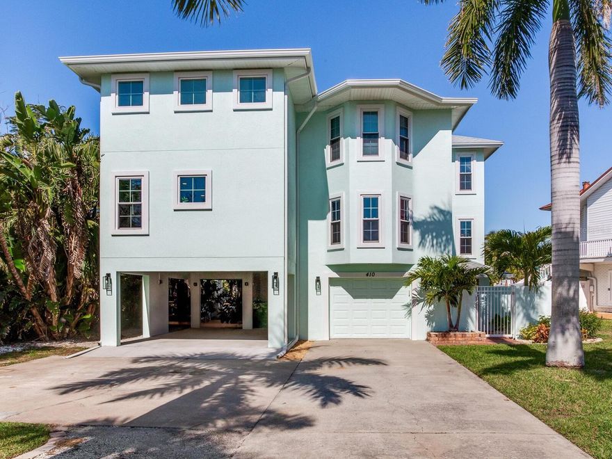 ELEVATED WATERFRONT LIVING | POOL | PRIVATE DOCK | NEW ADDITION | MODERN UPDATES Welcome to 410 140th Ave E in the heart of Madeira Beach — a beautifully elevated waterfront residence where modern coastal design meets relaxed Florida living. This light-filled home offers clean architectural lines, fresh contemporary finishes, and tranquil water views that capture the essence of beachside luxury. The exterior welcomes you with a soft coastal palette, tropical landscaping, and elevated construction designed for both curb appeal and peace of mind.  Inside, the open and airy layout is enhanced by updated flooring, neutral coastal tones, and an abundance of natural light throughout. The kitchen features crisp white cabinetry, sleek countertops, stainless appliances, and a functional breakfast bar ideal for everyday living or entertaining. Multiple living spaces provide flexibility for guests, a home office, or multigenerational living arrangements.  A brand-new addition completed in September significantly expands the home’s functionality, introducing an additional spacious family room, a private bedroom with its own ensuite bath, and a full laundry room — creating an ideal guest suite, in-law quarters, or private retreat. This thoughtful expansion blends seamlessly with the original design while adding valuable square footage and versatility.  The primary suite serves as a tranquil escape with soothing coastal hues, generous proportions, and access to outdoor views. The primary bath is beautifully appointed with elegant finishes, a freestanding soaking tub, and designer lighting that creates a spa-like ambiance.  Step outside to your private backyard oasis where lush tropical landscaping surrounds a sparkling pool and paver deck overlooking the water.  Boating enthusiasts will appreciate the composite dock and jet ski lift, completed in 2023 and capable of housing a pontoon boat. Enjoy direct water access for kayaking, paddleboarding, jet skiing, fishing, or a quick boat ride to the Gulf through Johns Pass Inlet. From your private dock, you can marvel at daily sightings of dolphins, occasional manatees, and breathtaking sunsets. Located just one mile from the famous Johns Pass Village, the home offers easy access to vibrant shopping and dining. This elevated coastal dream truly embodies the ultimate beach lifestyle.  Additional upgrades include a new roof, hurricane-impact windows, and sliding glass doors, offering enhanced durability, energy efficiency, and storm protection.   A rare opportunity to own a thoughtfully updated waterfront home where every day feels like a vacation.