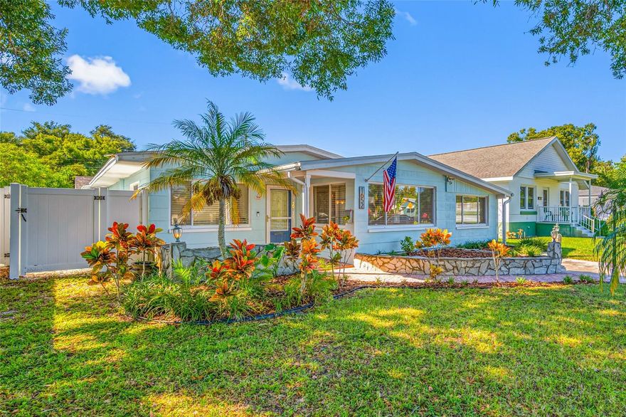 One or more photo(s) has been virtually staged. Close to everything!  This beautiful 2-bedroom, 2 full bathroom, plus an office, plus a huge garage AND an ample screened porch, is located in one of the most desirable neighborhoods in St. Pete- Greater Woodlawn.  Just steps away from Woodlawn Circle with its historical nature and homes and just a short distance from the new Blend coffee shop on 16th Street and the new Violet Stone Pizzeria!  Downtown St Pete is minutes away.   With mature trees, green lawns and long-time neighbors, you will enjoy coming home to your private sanctuary.  As you enter the home you will notice how light and bright it is.  With newer blinds throughout and many large windows.  The refinished terrazzo and tile floors gleam to add even more light.  The kitchen boasts granite countertops and has abundant storage and cabinets as does the home itself, which you don’t often see in homes of this size.   The two large bedrooms also have plenty of light and good sized closets, and the large bonus room can easily be used as an office, playroom or even a den.   The backyard is gorgeous with its low maintenance, professionally landscaped yard, and a very large screened porch, which is perfect for nights by the fire pit, BBQs or just chatting with friends.  The extra large (24x22!) garage has so many possibilities!  Parking for your boat, smaller RV, or 5th wheel, adding a workshop, creating an art studio, running a business out of your home, or leaving it as is to easily park 2 or more cars inside.  The garage doors were recently replaced. The HVAC & Ductwork were replaced in 2023 & 2024 respectively.  The washer and dryer DO convey, and they are only 1 year old.  The exterior was painted in 2024, and the vinyl fence was replaced then as well.  This home has so much to offer and is in the perfect location.  Be sure to see it before it is gone!