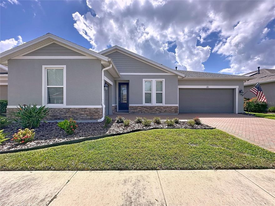 Rare find, only a few of these models were built. This home was the Builder's  Model in the Coveted Trilogy Resort Lifestyle Community!
Curb appeal and a sprawling open-concept design highlight this rare 4-Bedroom home with an additional Golf Cart Garage. Featuring wood-look tile throughout main living areas and two bedrooms.**Gourmet Kitchen showcases an expansive island, quartz countertops, abundant white cabinetry with pot drawers, decorative backsplash, stainless steel appliances, gas cooking, double oven, and French door refrigerator**Relax and entertain outdoors on the Covered Lanai with electronic hurricane screen, additional paver hardscape, and space ideal for BBQs**The Primary Suite includes dual sinks, large walk-in closet, tiled-to-ceiling shower with frameless glass enclosure, private water closet**Laundry Room with abundant cabinets, sink, and front-load washer/dryer**Bright, open concept floorplan perfect for entertaining** Enjoy the ease of high-speed internet, security monitoring, and full landscaping and lawn care—so you can focus on living your best life in a Guard Gated Community. At the center of it all is the 57,000 sq. ft. Magnolia House, a spectacular hub offering:**A members-only restaurant & bar with live entertainment**Indoor/outdoor heated pools & a state-of-the-art athletic club**Artisan studio, poker room, culinary kitchen & creative spaces**Sports courts for tennis, pickleball, bocce, billiards & a Golf Simulator** Clubs for every hobby and interest**A show-stopping Event Center with professional stage & AV setup**this is more than just a neighborhood, it’s a lifestyle upgrade where connection, wellness, excitement, and belonging come together every day**45 minutes to Orlando theme parks including Universal and Disney World and Orlando International Airport**1.5 hours to Florida beaches and Port Canaveral Cruise Terminal**Live Your Best Life at Trilogy.