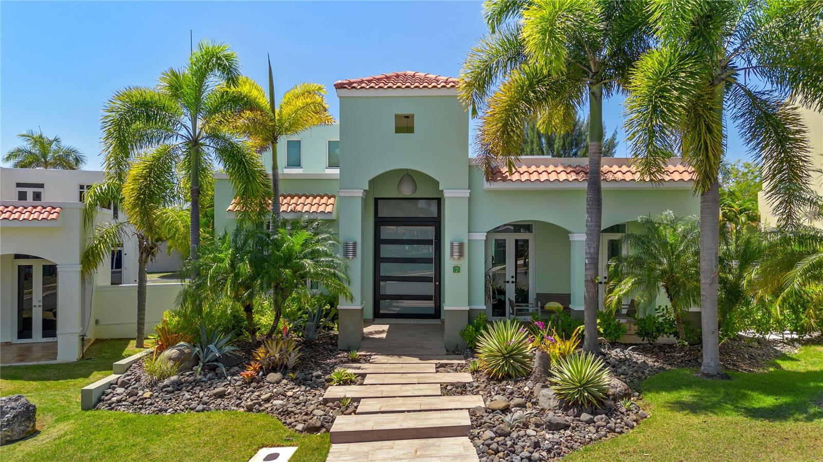 Discover Your Dream Home in Treasure Point
Nestled within the exclusive Treasure Point community of Vega Alta, this remarkable residence spans 4,426 ft2 on a 639 m2 lot¦—the perfect blend of elegance and comfort.
Key Features
- Bedrooms & Bathrooms: Four spacious bedrooms, accompanied by three full baths and two well-appointed half baths—ideal for family living and entertaining.
- Living Spaces: A generous family room, a formal living area, and an open-concept kitchen promise seamless flow and contemporary living.
- Outdoor Oasis: Step outside to a beautiful pool, lush landscaping, and two covered terraces complete with a full outdoor kitchen and built-in BBQ for those unforgettable gatherings.
- Sustainable Living: Equipped with 46 solar panels, three Tesla batteries, and a water cistern, this home is designed for sustainability and energy efficiency.
- Community Amenities: Enjoy 24/7 security and access to two pools, tennis and pickleball courts, a basketball court, fitness center, sauna—and more—within the neighborhood.
Location Advantage
Just a 7-minute walk from the renowned Cerro Gordo Beach, residents can seamlessly blend serene coastal living with the comforts of luxury community life.
This exceptional property captures the essence of refined, sustainable living, seamlessly combining indoor elegance and outdoor leisure in one of Vega Alta’s most sought-after enclaves.